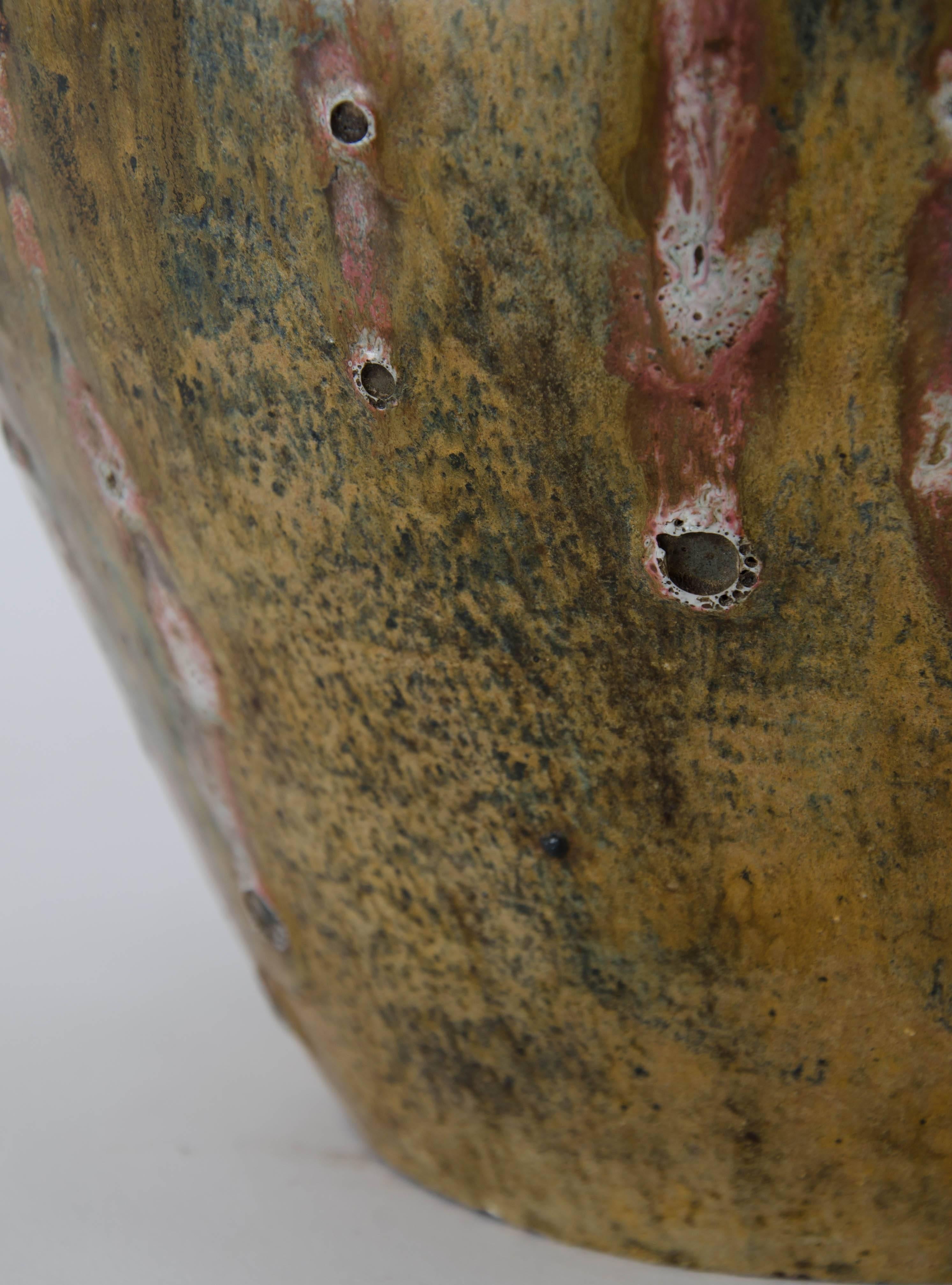 A large mid 20th century baluster vase with red wash decoration and mild vocanic glaze.
Signed L.Lemfrereus