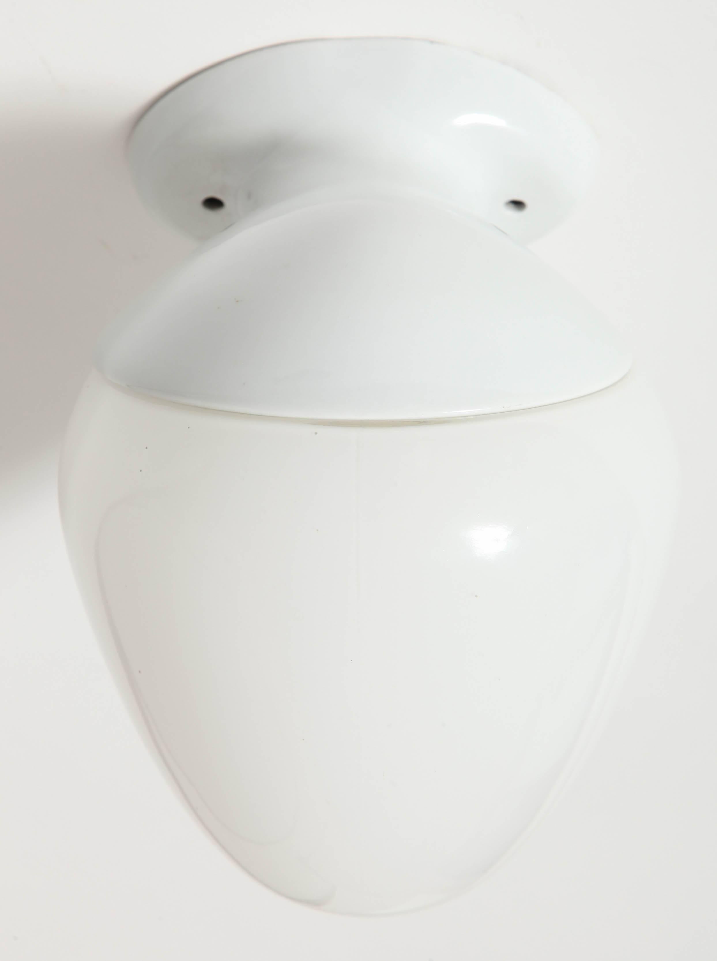 Uniquely shaped porcelain and glass sconce made during the Art Moderne Movement , a late type of Art Deco was characterized by curviliniar form, 
Bold geometric shapes, and streamline design.