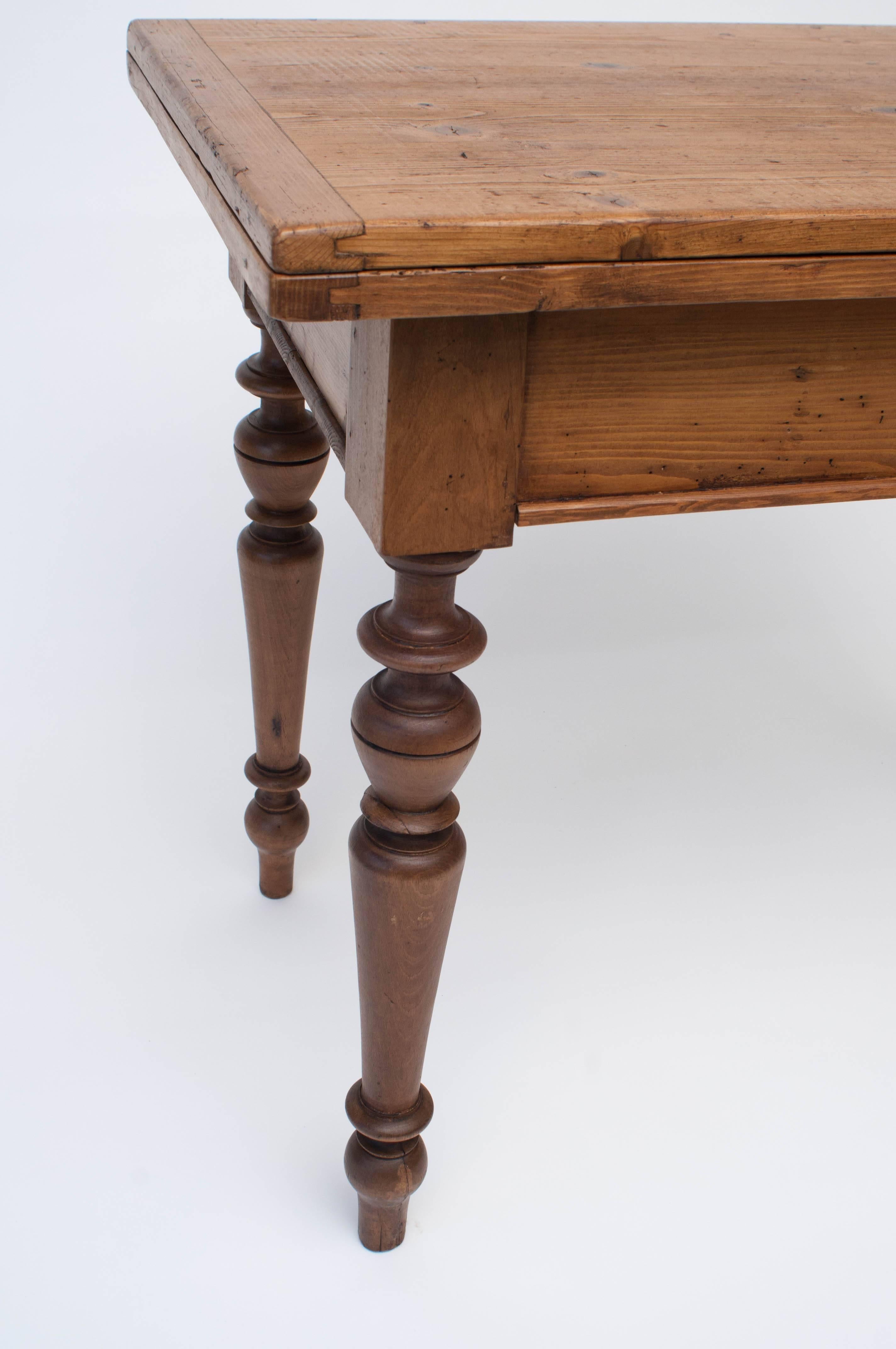 A beautiful little pine swivel top on four boldly turned beechwood legs.  Great for a small kitchen, dining room in a small apartment, or college dorm, the top pivots through ninety degrees and opens up to 50
