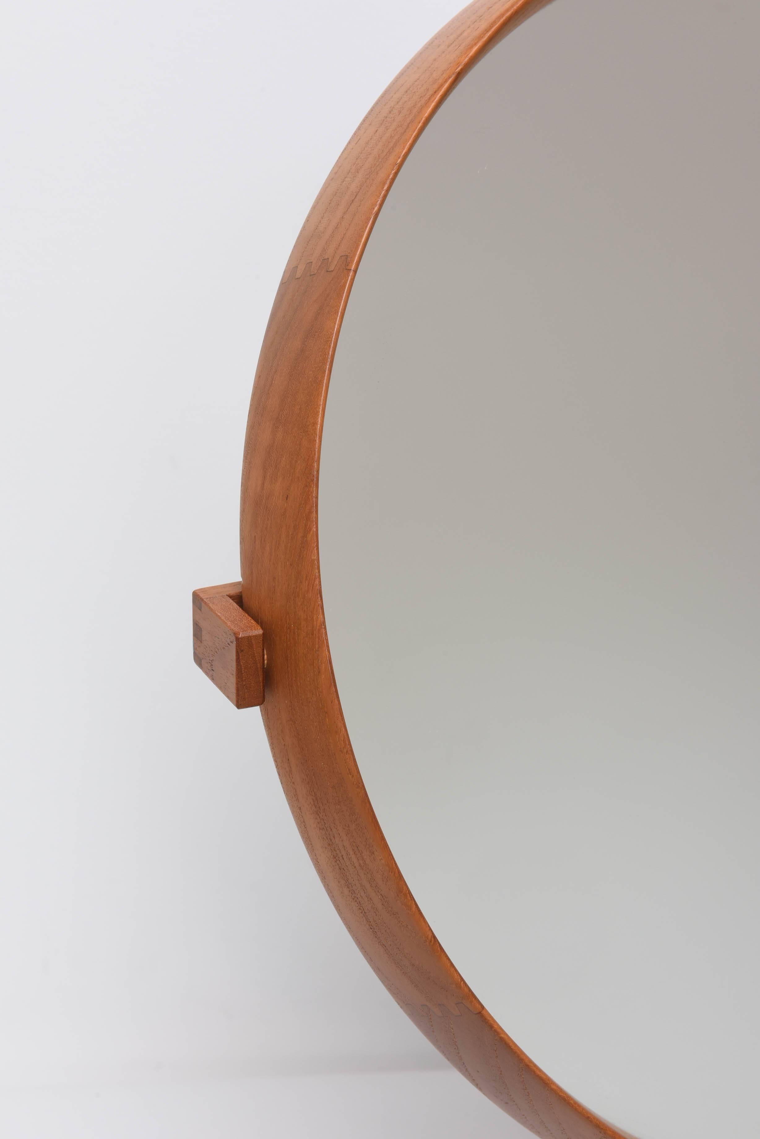 Swedish teak mirror designed to pivot on stainless steel base.