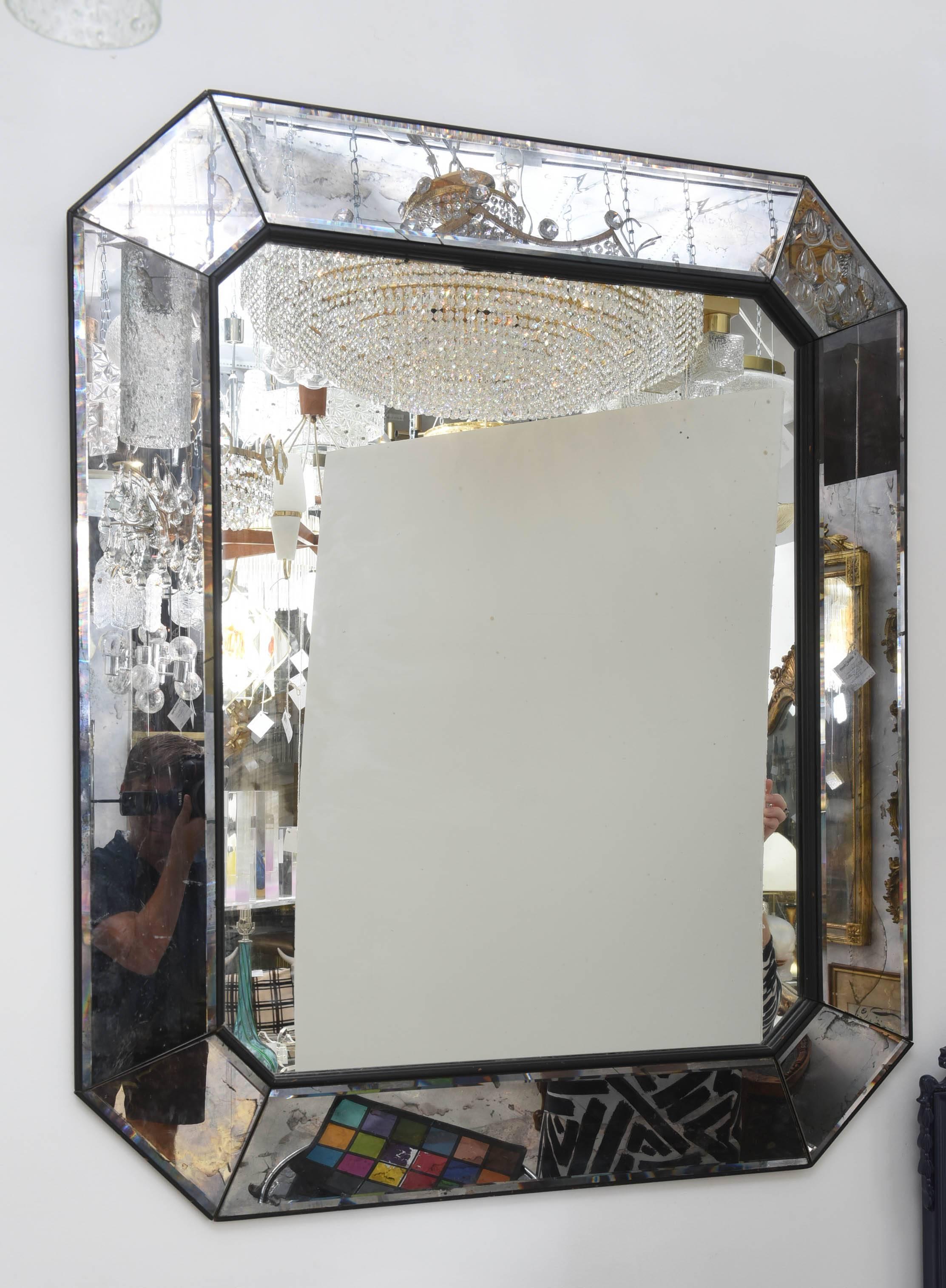 Distressed mercury glass mirrored with gem like facets and beveled edge.
 