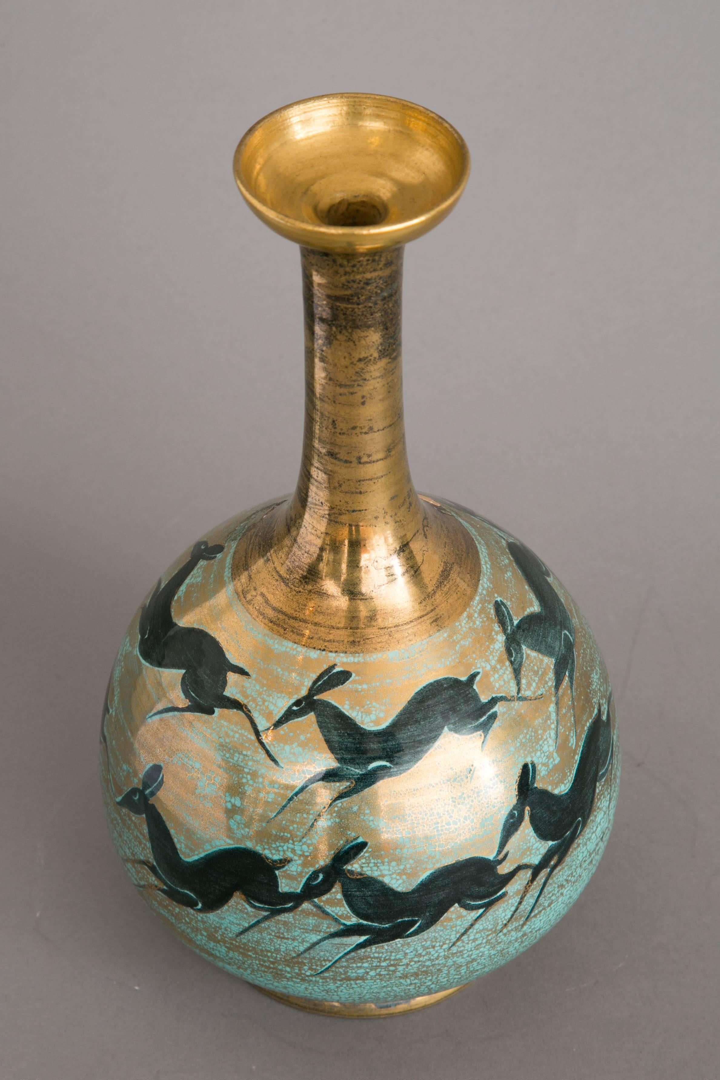 Refined vase with narrow neck on bowl base, 1950s, by Jean Mayodon (1893-1967) & Manufacture Nationale de Sèvres.
Gilt and light green enameled porcelain, ornamented with running black does.
Circular gilt base. Monogrammed M and Sevres.