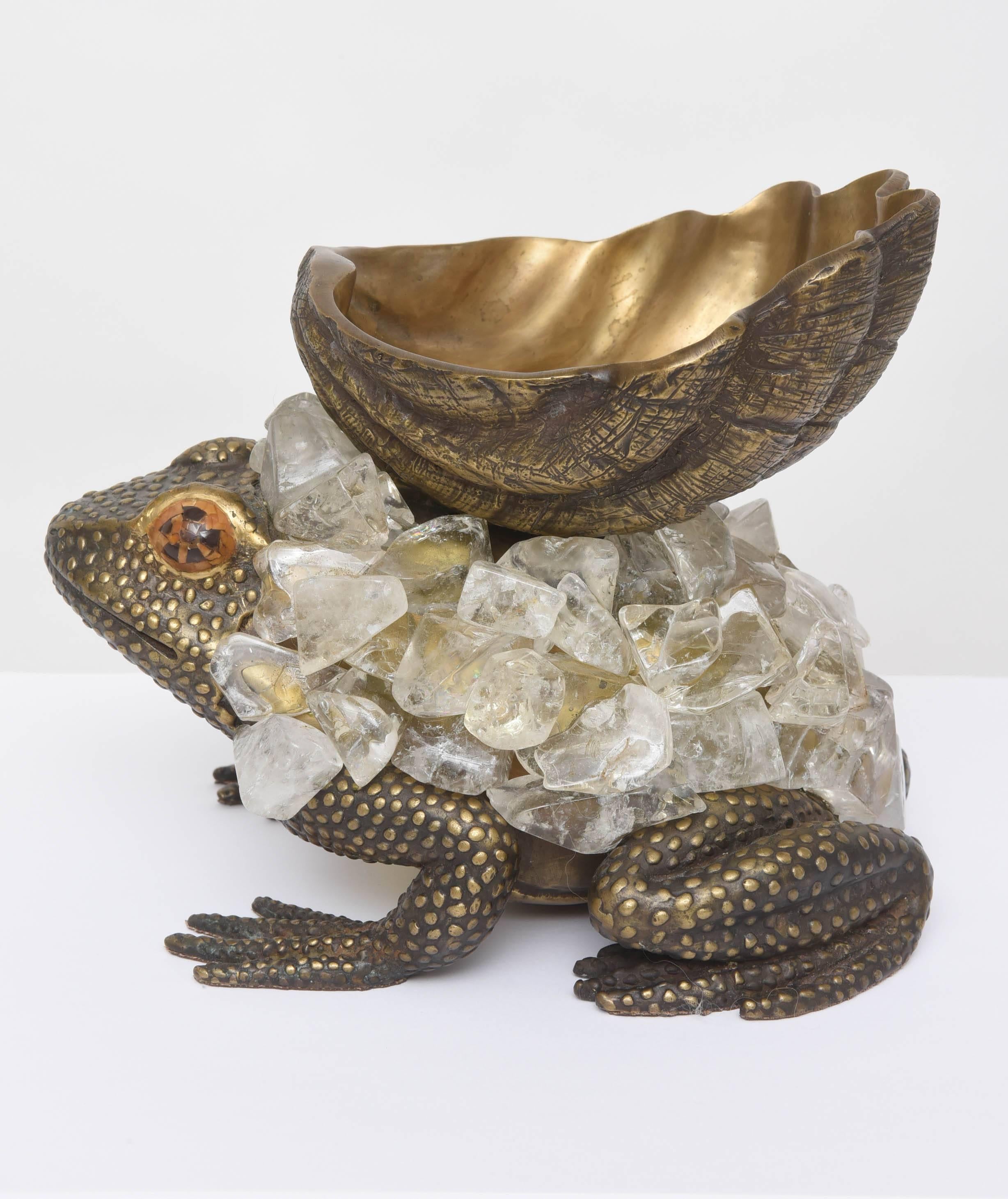 Bronze frog covered in crystals and holding an upturned shell that serves as a bowl.