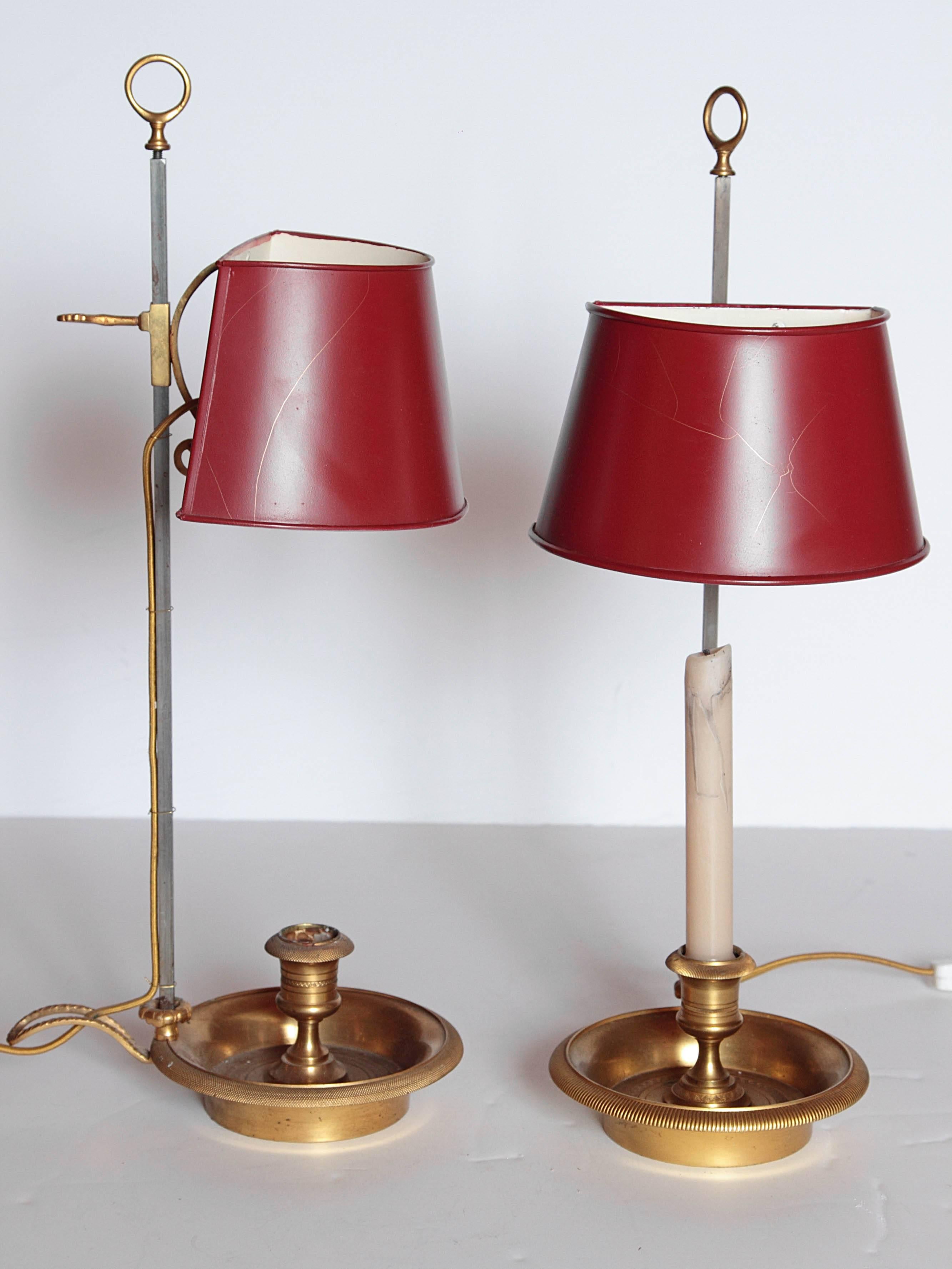 Pair of charming French gold bronze single candle lamps with red metal half-rounded shades, 20th century.