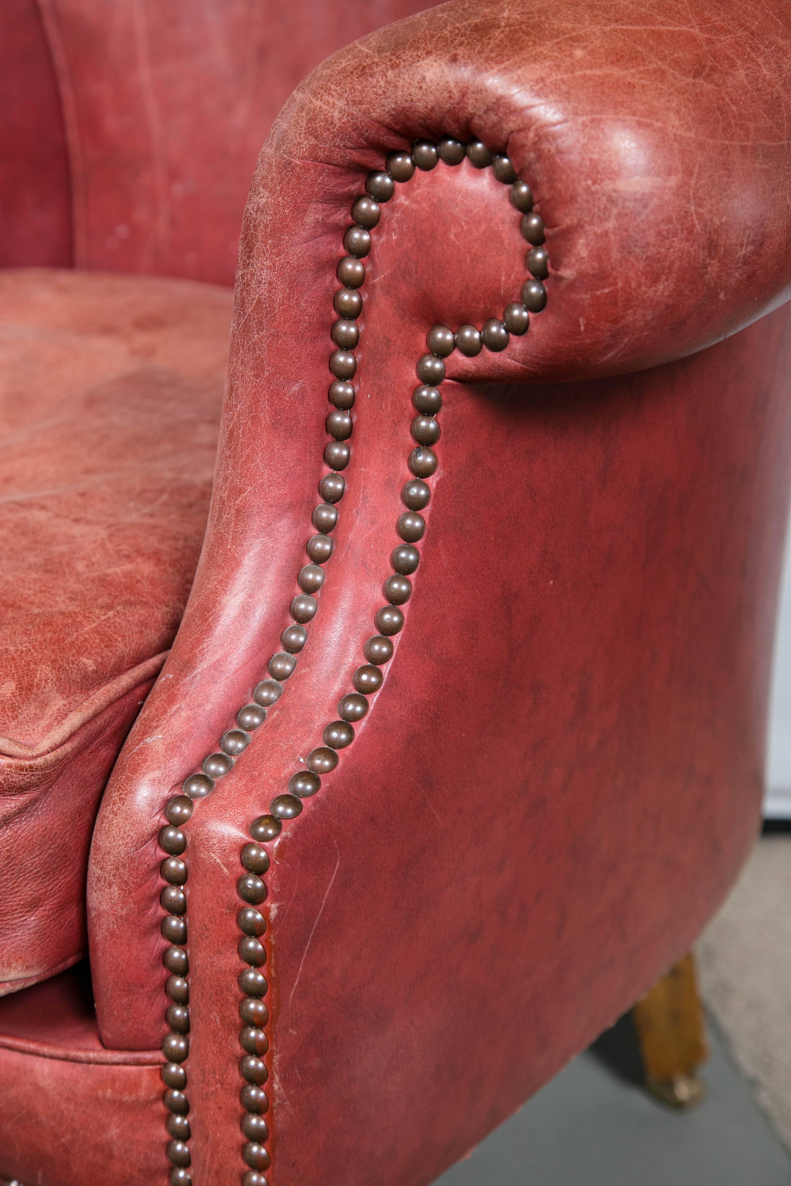 Vintage red leather wing chair with just the right amount of wear.