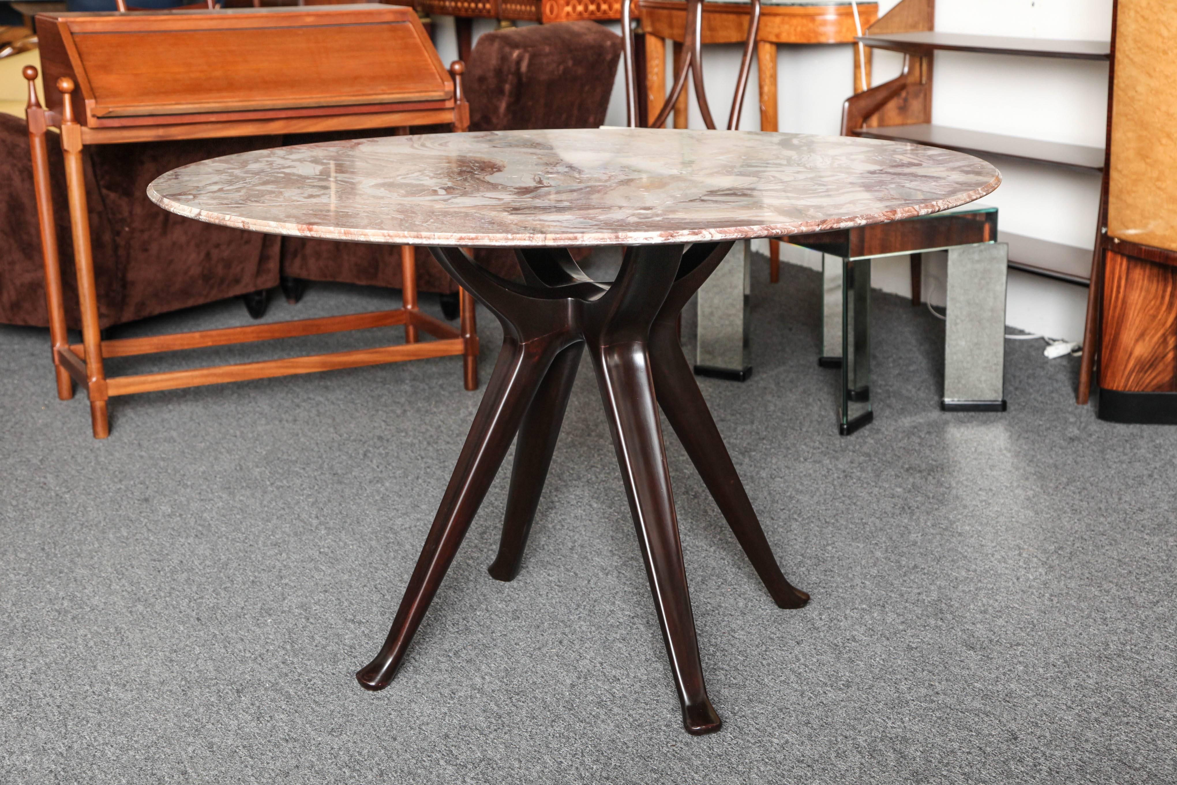 Stylish Osvaldo Borsani T40 dining table made in Milan, 1954. Carved mahogany base with great detailing on the legs, a top in beautifully grained marble. Table has two clip on leaves that can sit up to ten people, when opened 89" long x