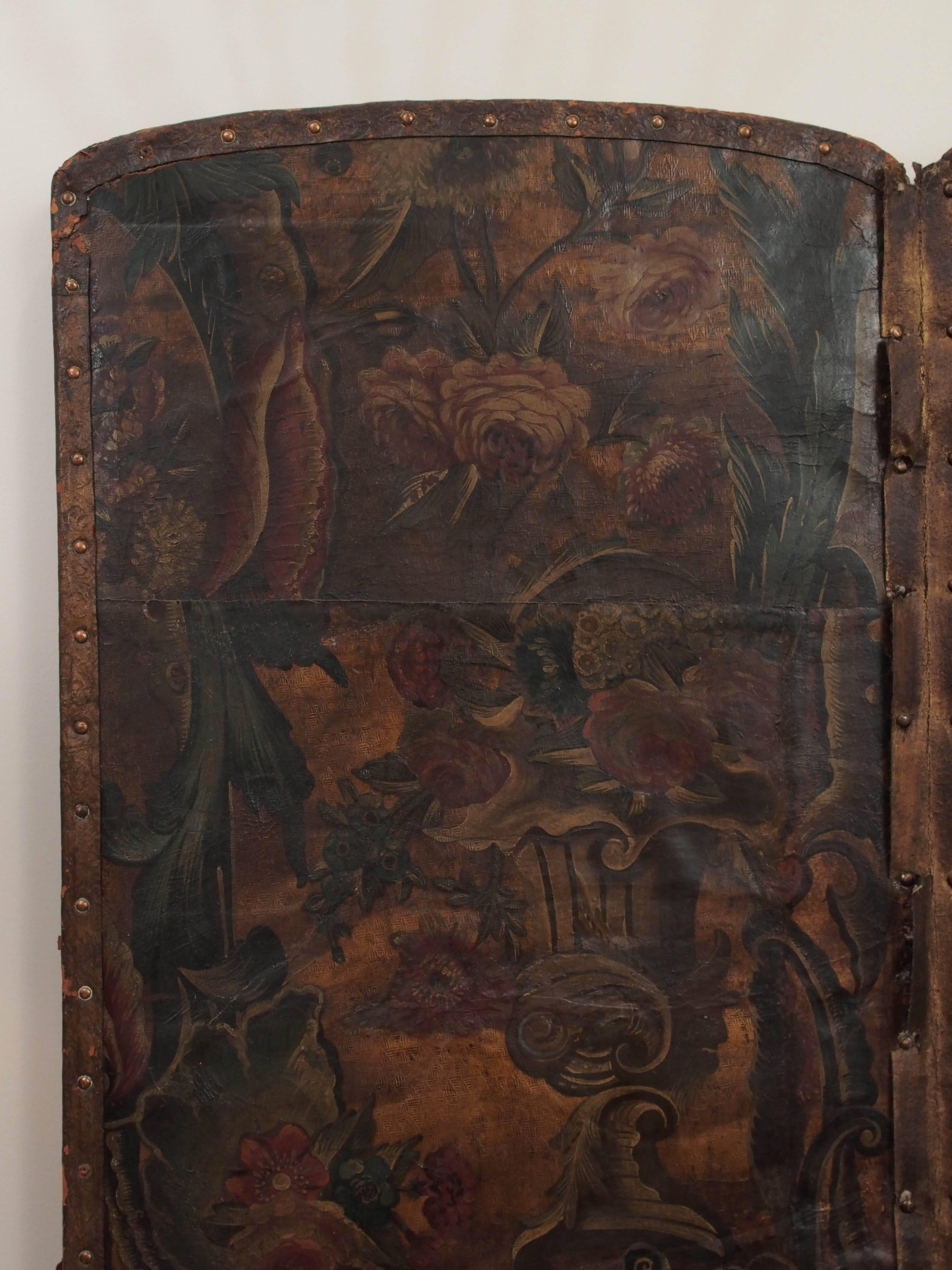 A Baroque embossed and polychrome four-panel leather screen, decorated with exotic birds, flowers, masks as fountain spouts, and a really cute squirrel. Panels are presented on a 20th century blackwood frame. 

European embossed and painted