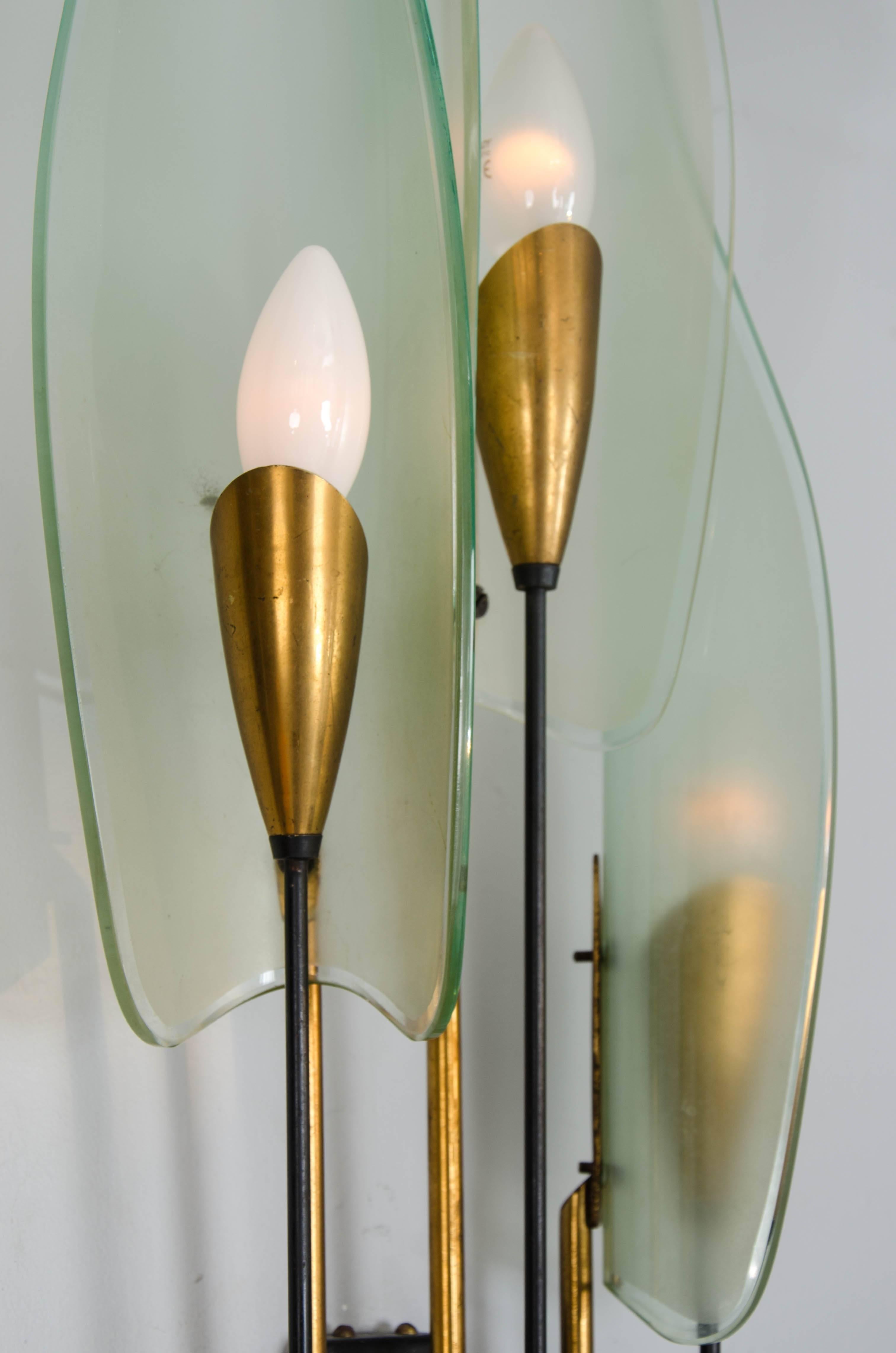 A pair of Italian wall lights in the form of dahlias and the style of Max Ingrand for Fontana Arte.
