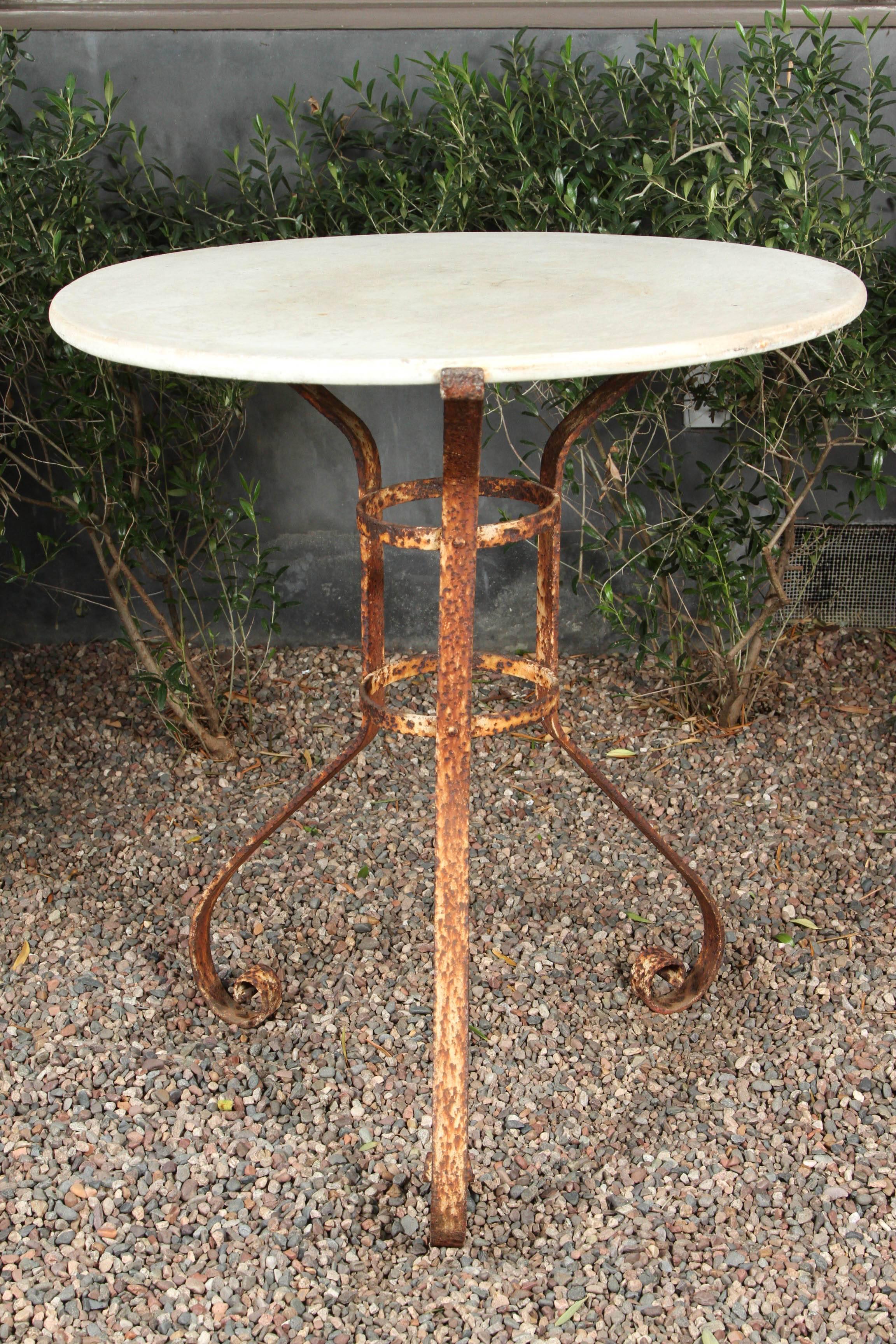 Round marble-top and iron garden table from late 19th century France. 