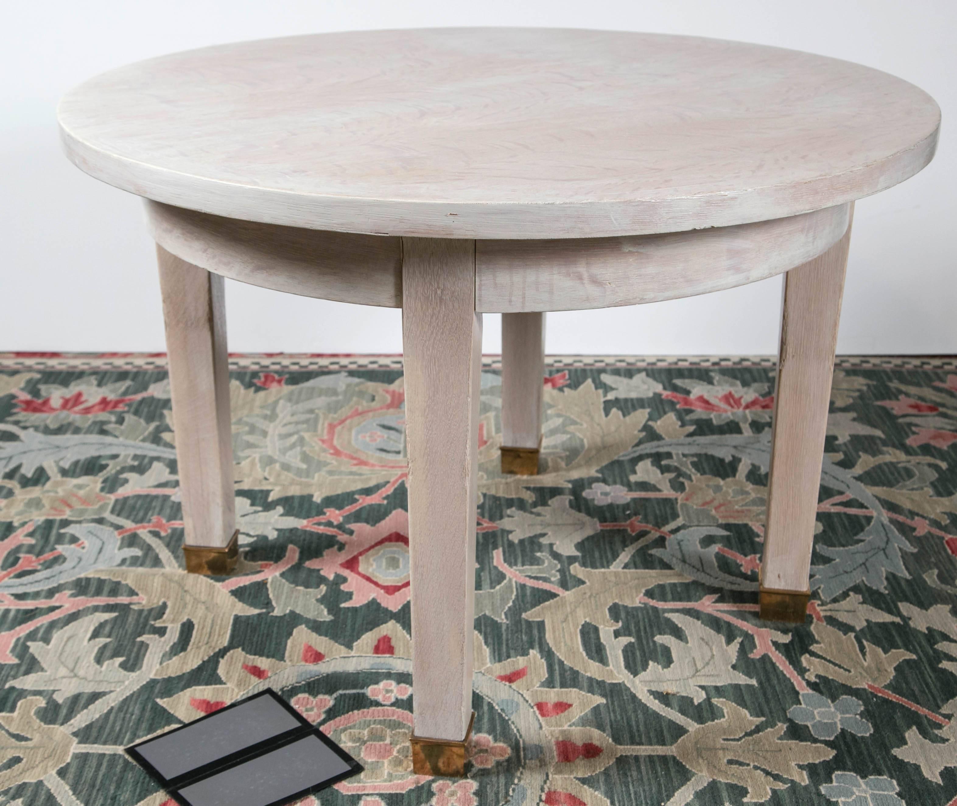 Round table, custom painted subtle pattern on squared tapered legs with brass feet. 