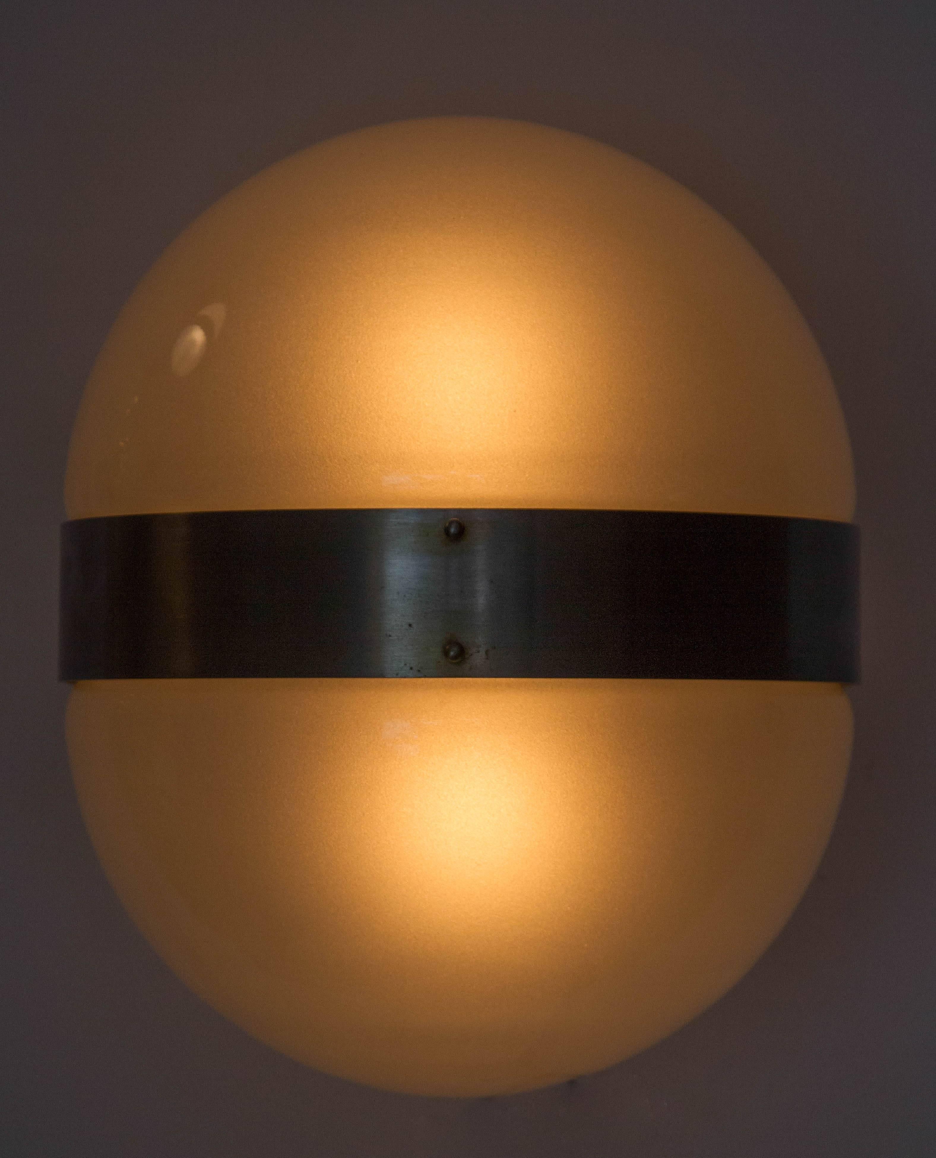 Nickeled brass and glass wall light designed in 1963 by Sergio Mazza for Artemide, Italy.
      