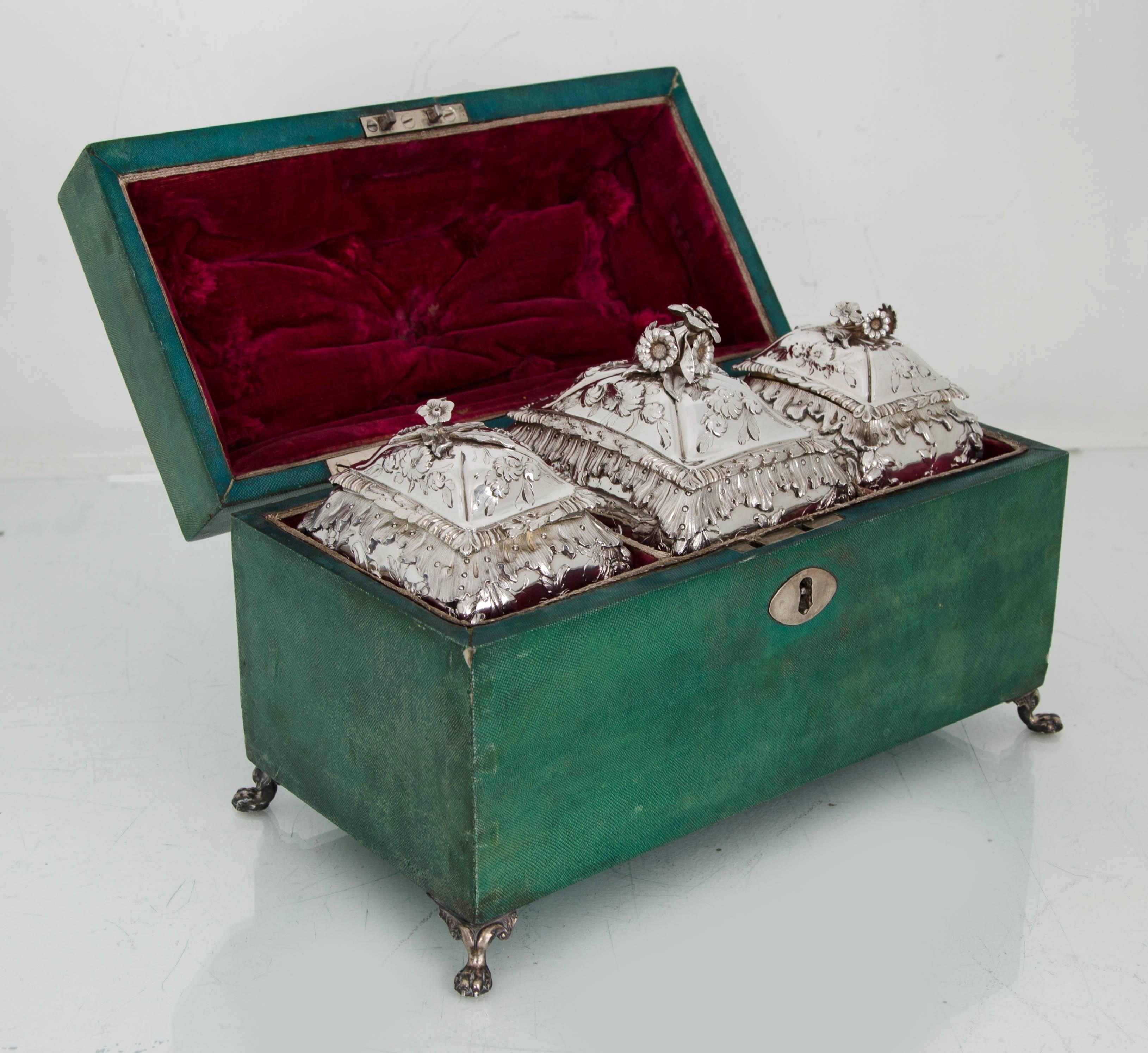Suite of three George III 18th/19th Rococo silver tea caddies in green shagreen box London 1764/1810 Thomas Foster and William Pitts.
 
A strikingly beautiful suite of three silver tea caddies rectangular with bombe sides. The caddies have