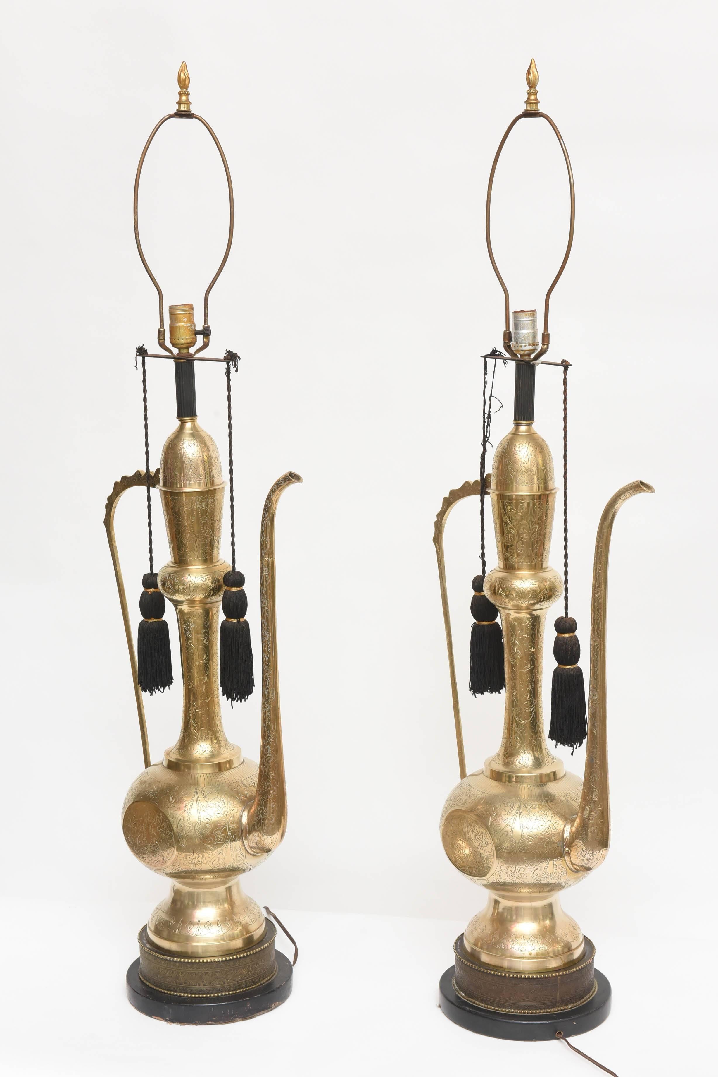 Exotic and dramatic pair of hand-wrought brass, beautifully etched Indian 'Aladdin' Tea Pitcher lamps. With decorative black tassels. Very large-scale! (Sold without shades).