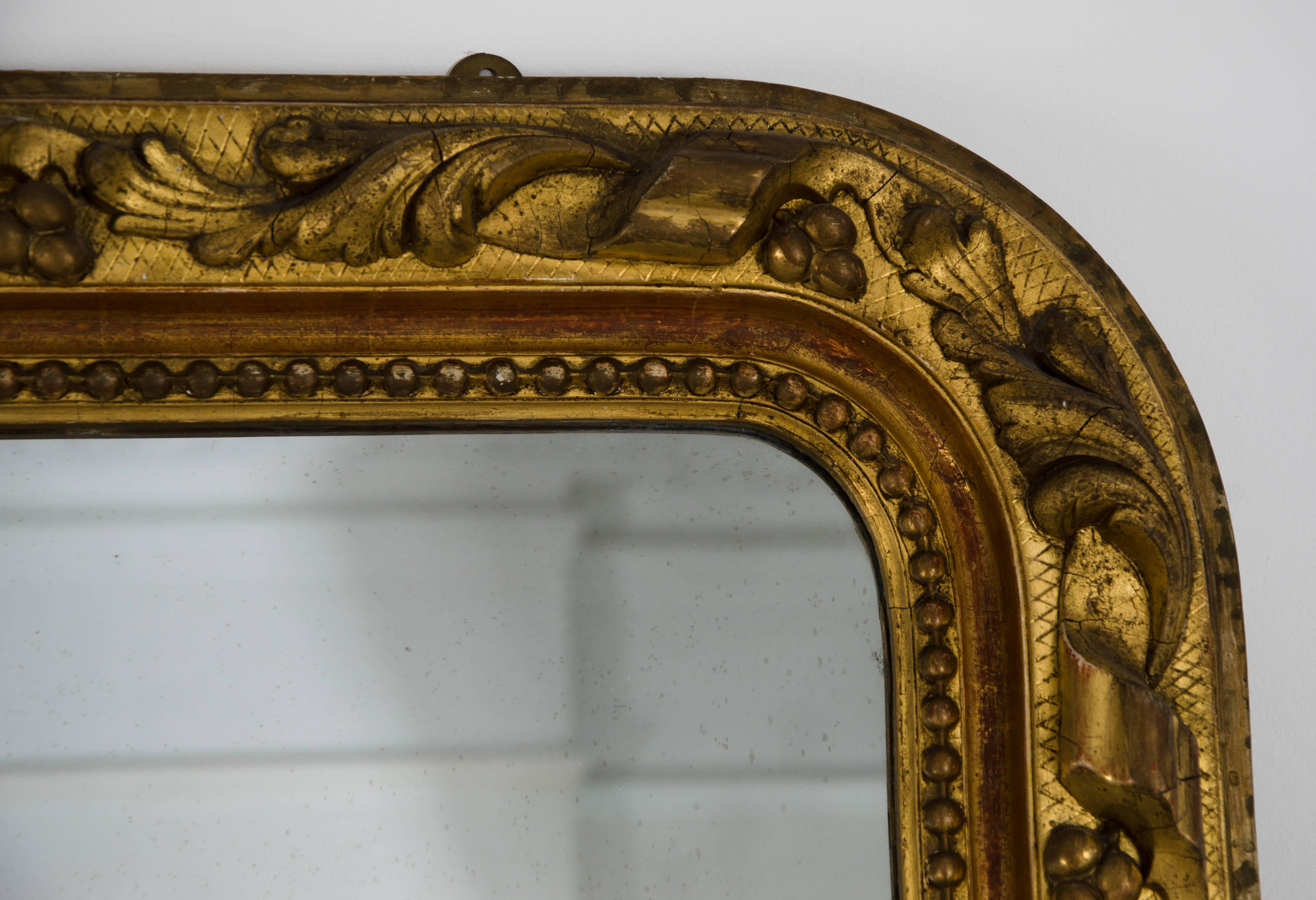 This lovely gilded mirror is decorated with scrolls, berries and leaves.  The gilding has an especially good, original colour.  The plate is original.

Basic to the door shipping (generally by sea 8-10 weeks +), is included in the price to the value