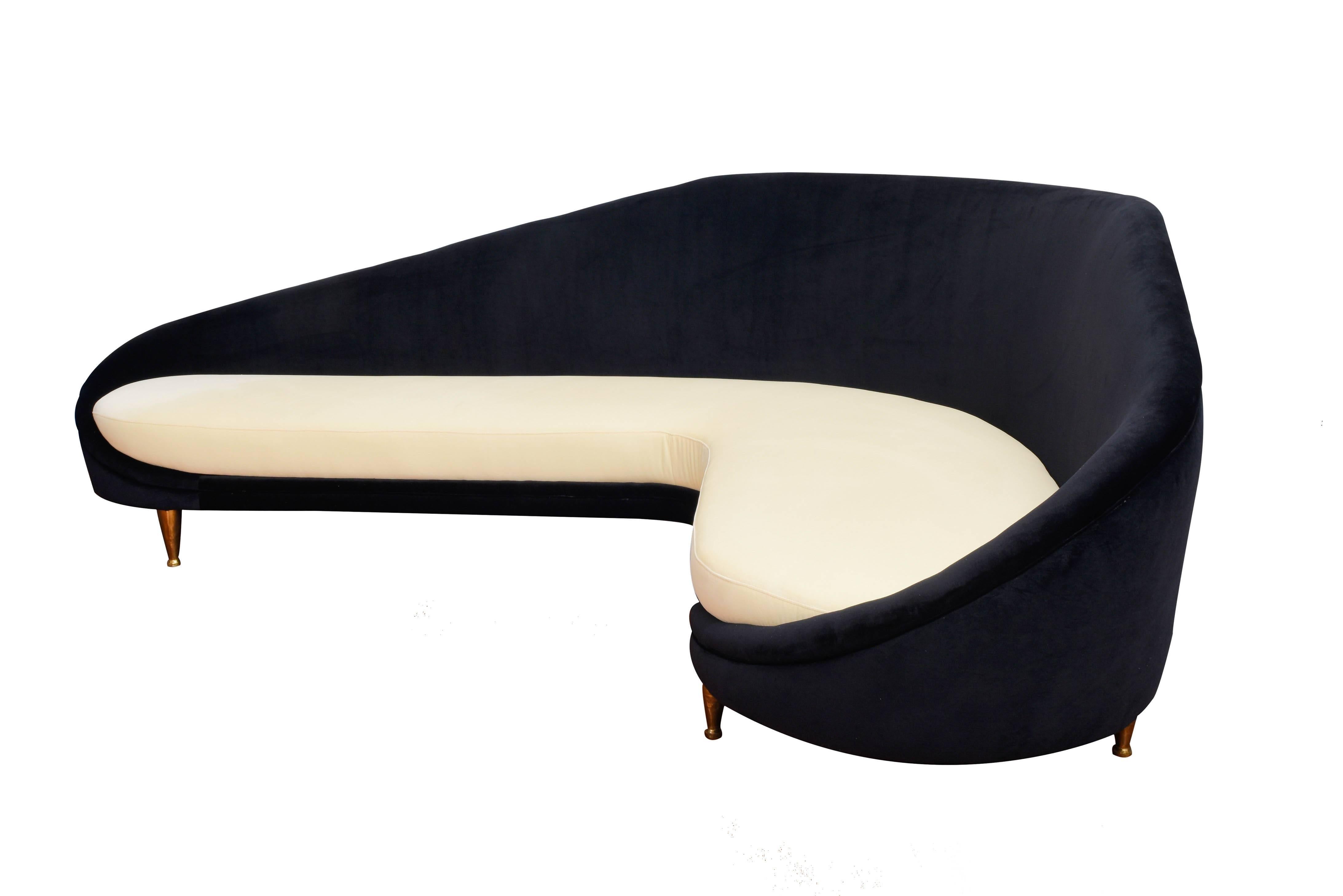 Elegant, Italian curved sofa. This piece has been re-upholstered in velvet, black and cream. It has brass feet. 
cm 240x170x90
