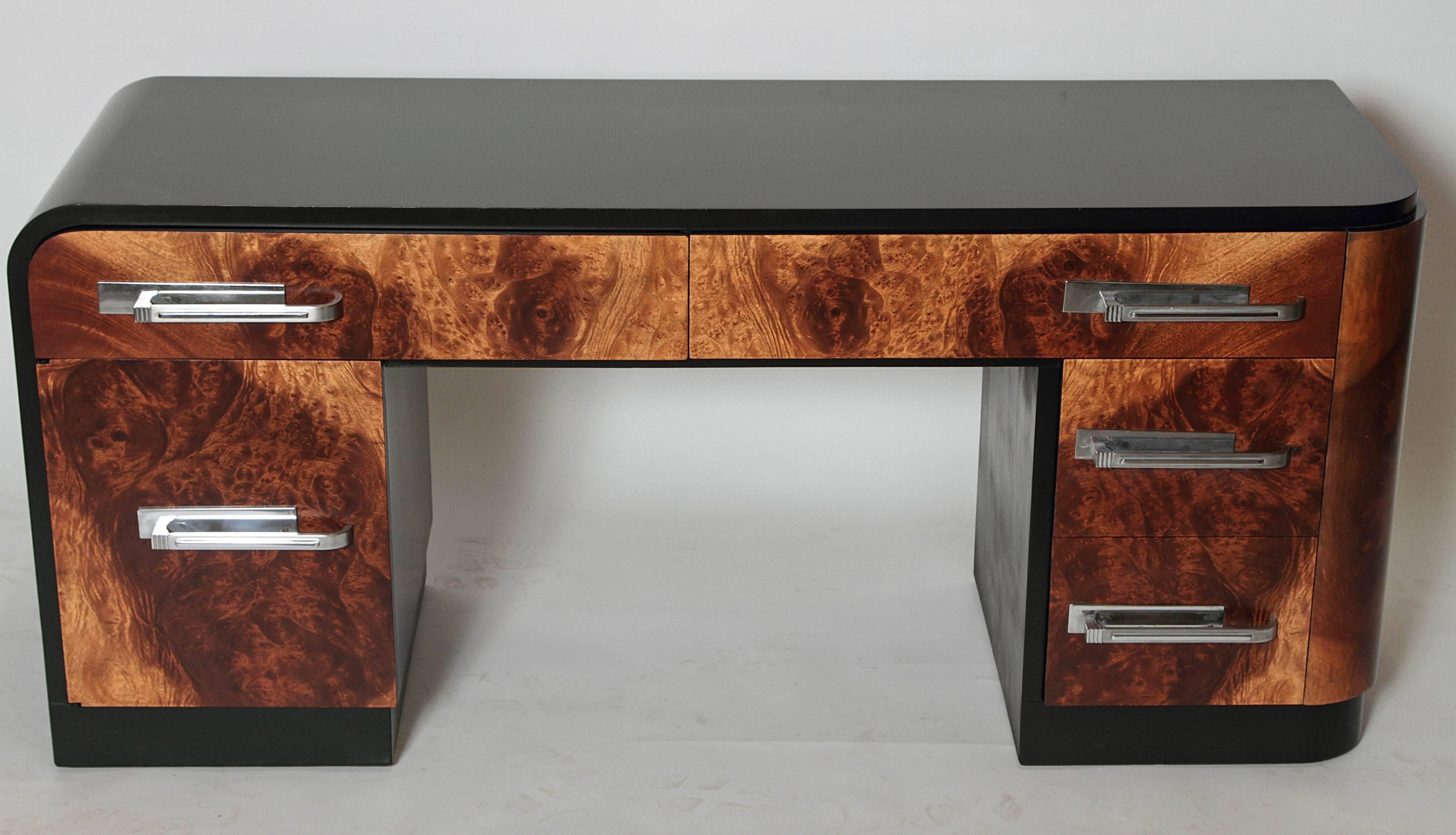 Original holographic exotic burl fronts, black lacquered top/base/side, large chrome pulls.
A great streamline original Deskey design for Widdicomb, with obverse rounded top left edge and right side.

Contact Dealer for stool / mirror