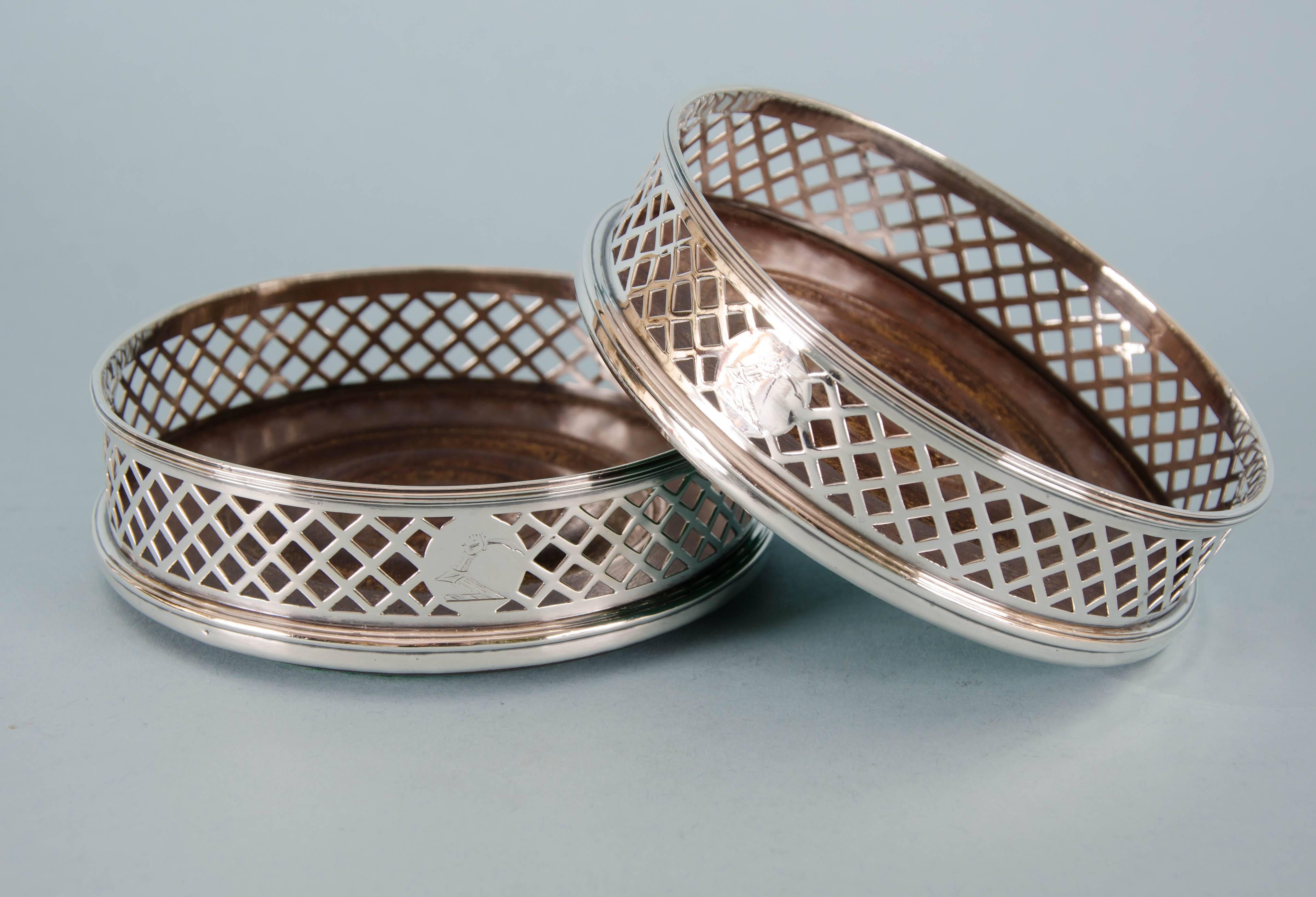 Smart pair of well made George III pierced-sided sterling silver wine coasters.
Made by Michael Plummer in London in 1797.
The sides of the coasters are pierced in lattice pattern with a solid silver disk on one side of each coaster on which is