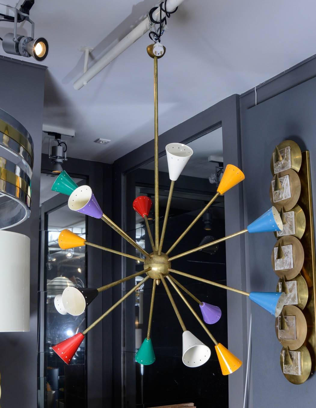 Nice and colorful pair of Sputnik chandelier in the style of Stilnovo.
Entirely made of brass, each of the sixteen arms of light are ended by a colored cone.