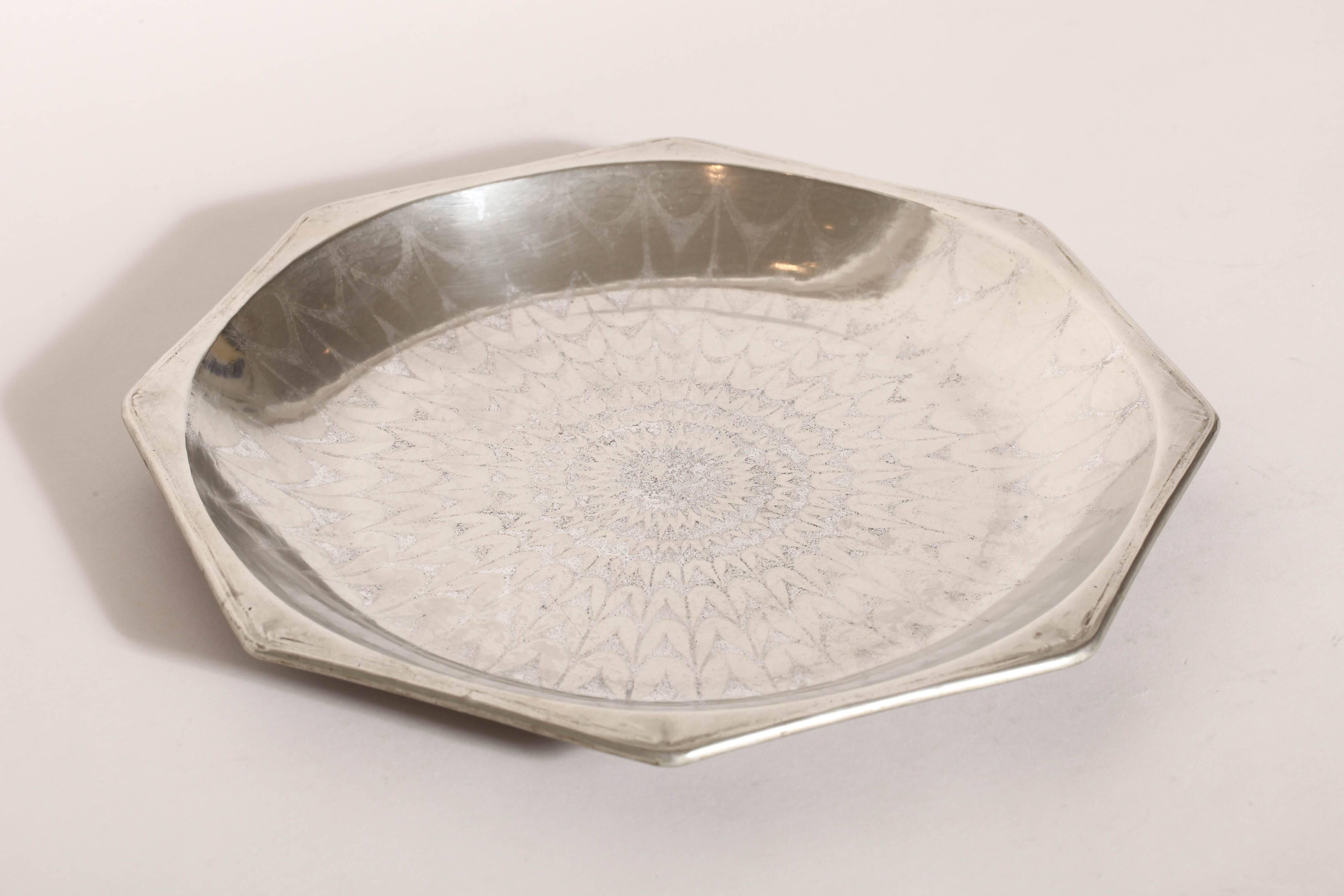Octagonal maillechort tray with intricate silver design and with rolled rim.
Inscribed 