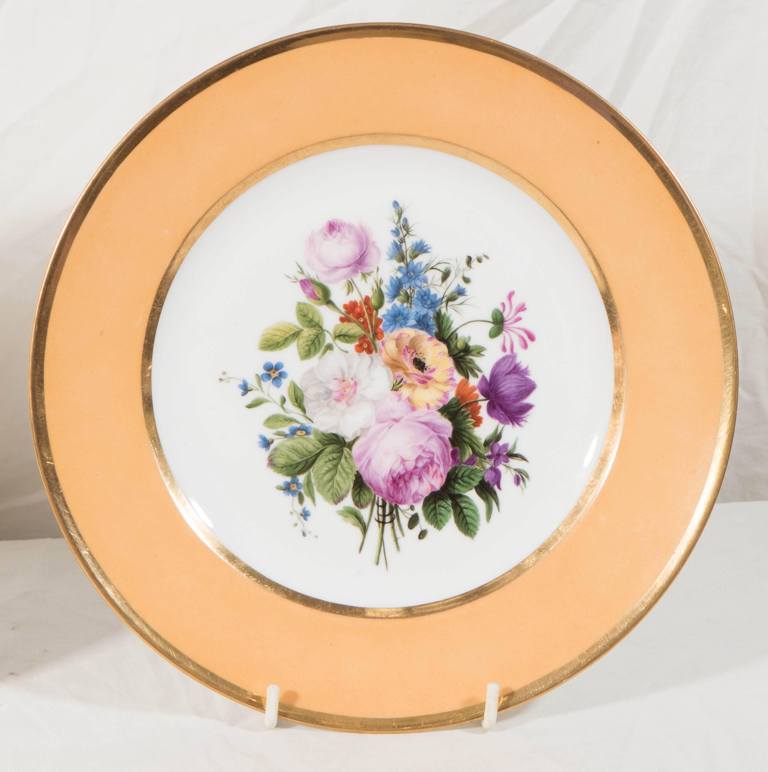 We are pleased to offer a pair of beautiful Sèvres porcelain dishes each with a hand-painted bouquet of exceptionally well painted flowers in soft pinks, blue, purple, and yellow. The center bouquets are complemented by a rich apricot