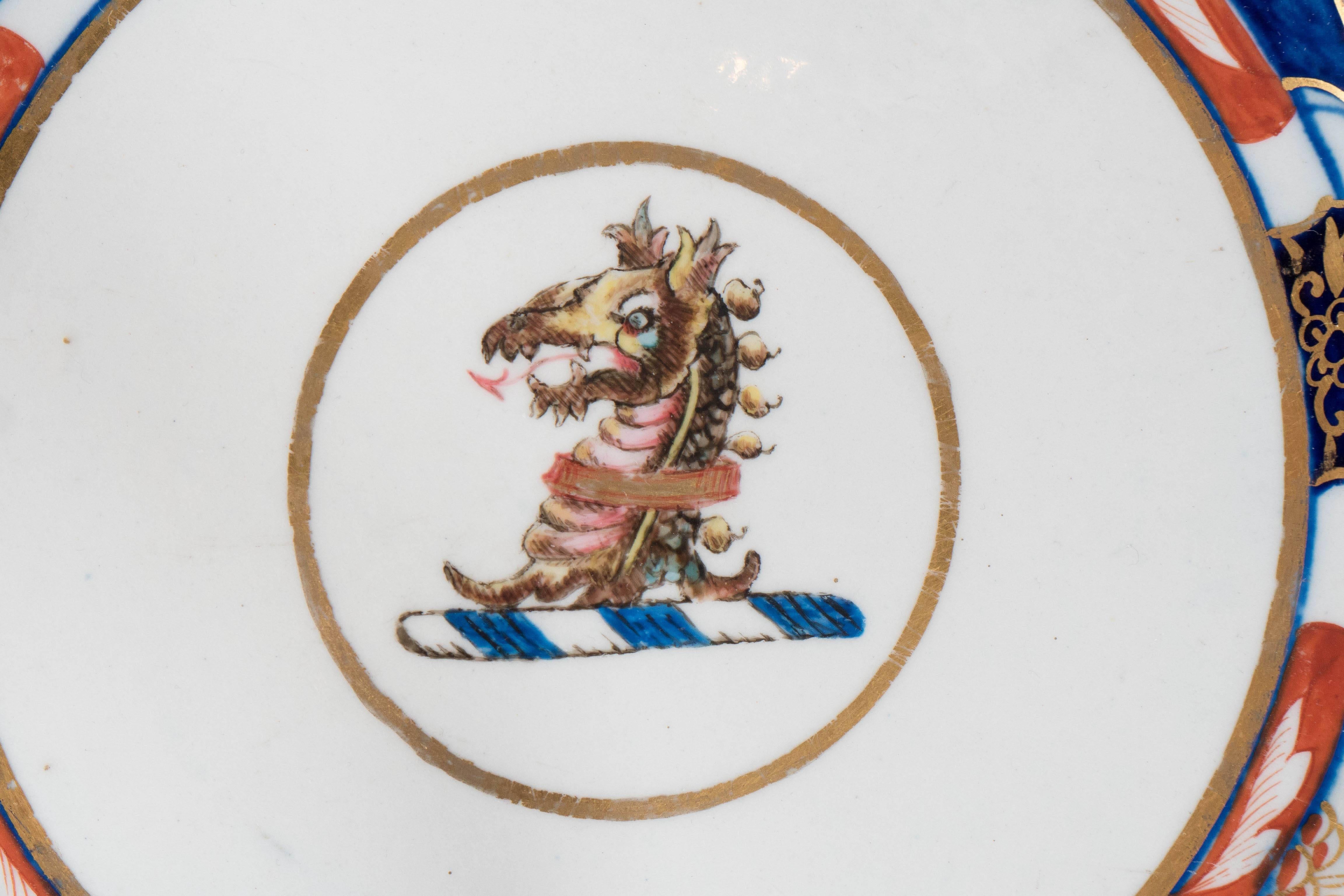 A Coalport armorial dish painted in the 