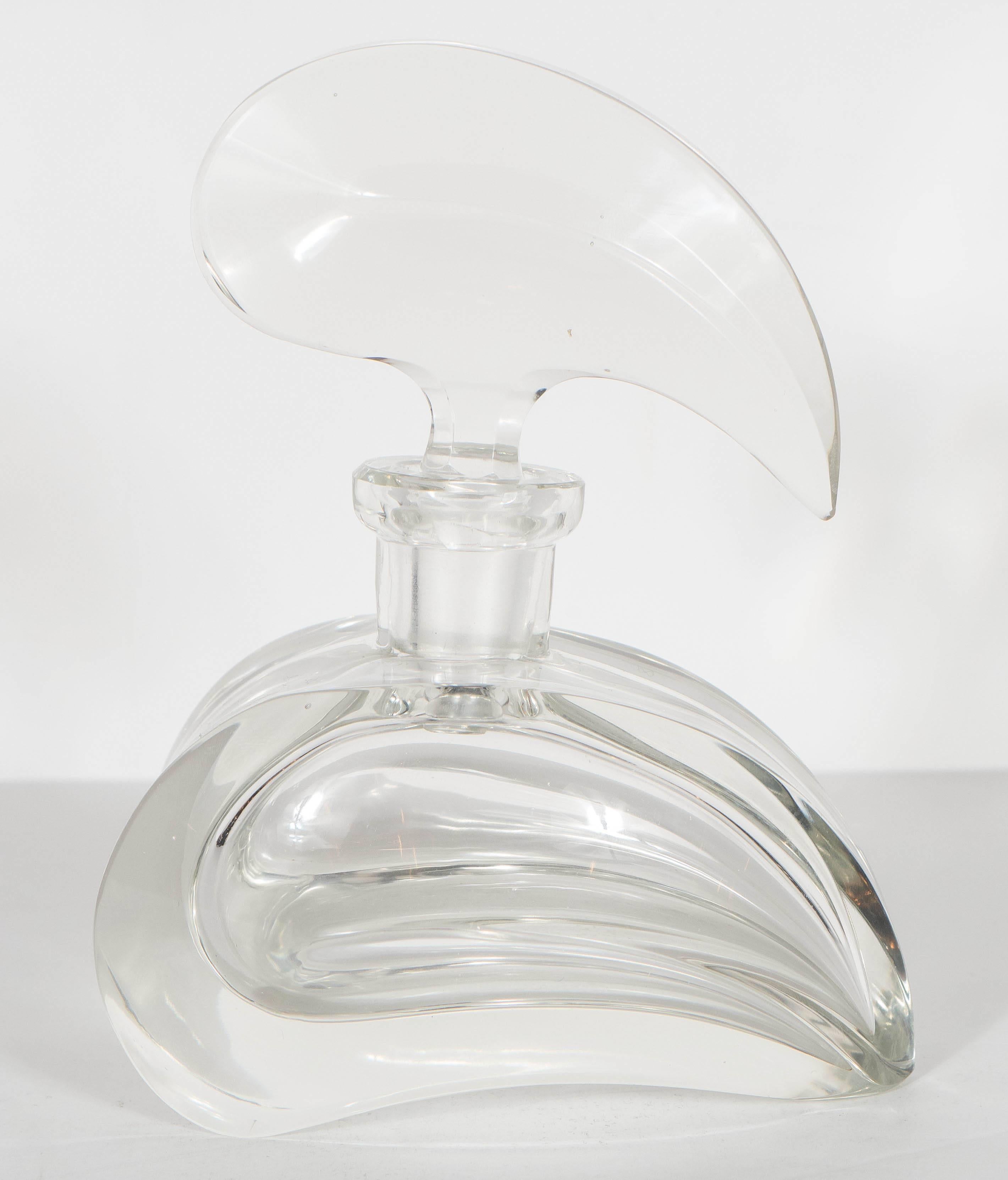 This elegant perfume perfume bottle features a streamline assymetrical design in tear drop form. It would add a great presence to any vanity or dressing table. It is in mint condition. 