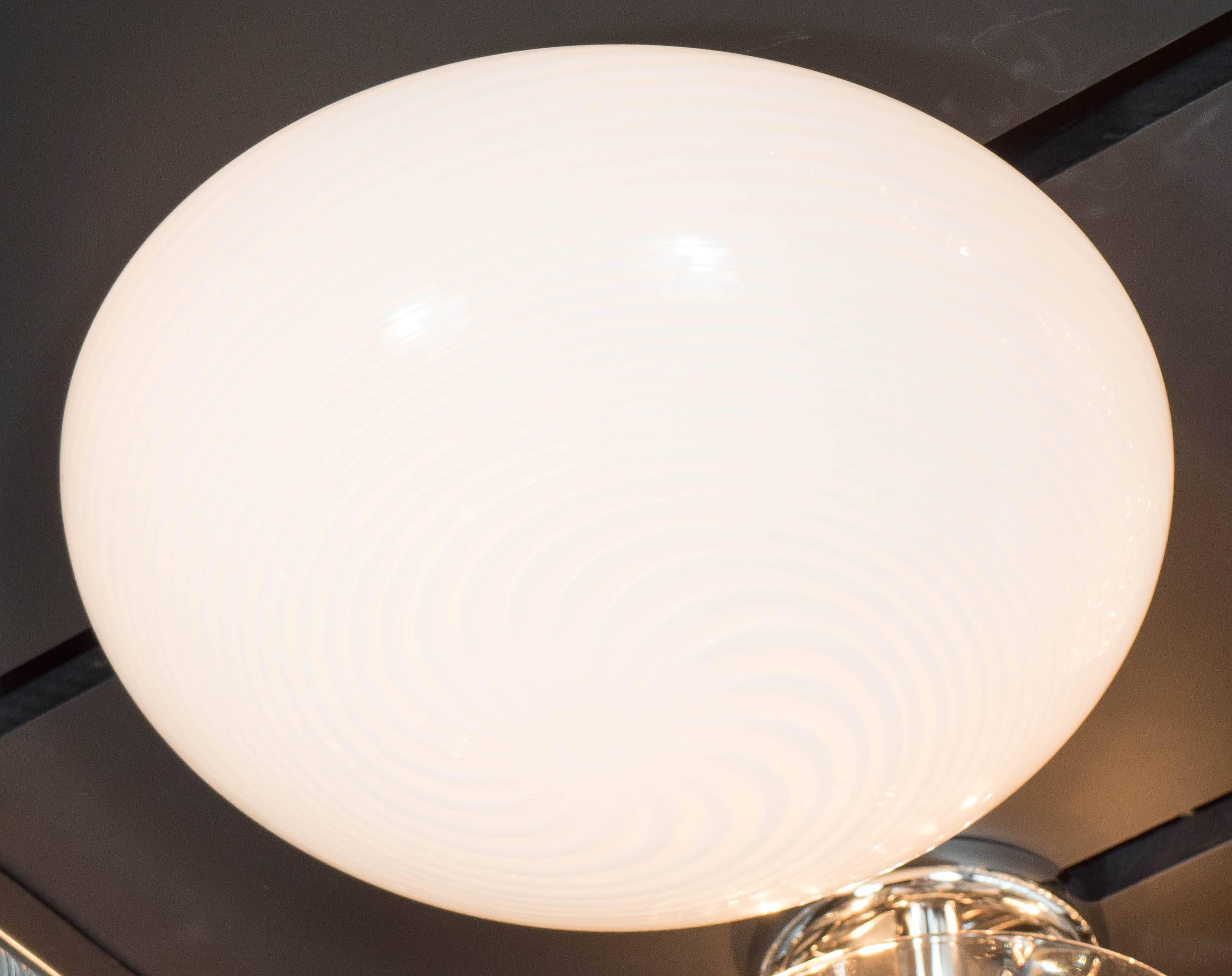 This sophisticated Mid-Century Modernist flush mount chandelier by Barbini features a pearl on white swirl Murano glass dome shade. When lit, the glass diffuses the light consistently throughout the shade enhancing the swirl detail. It is newly