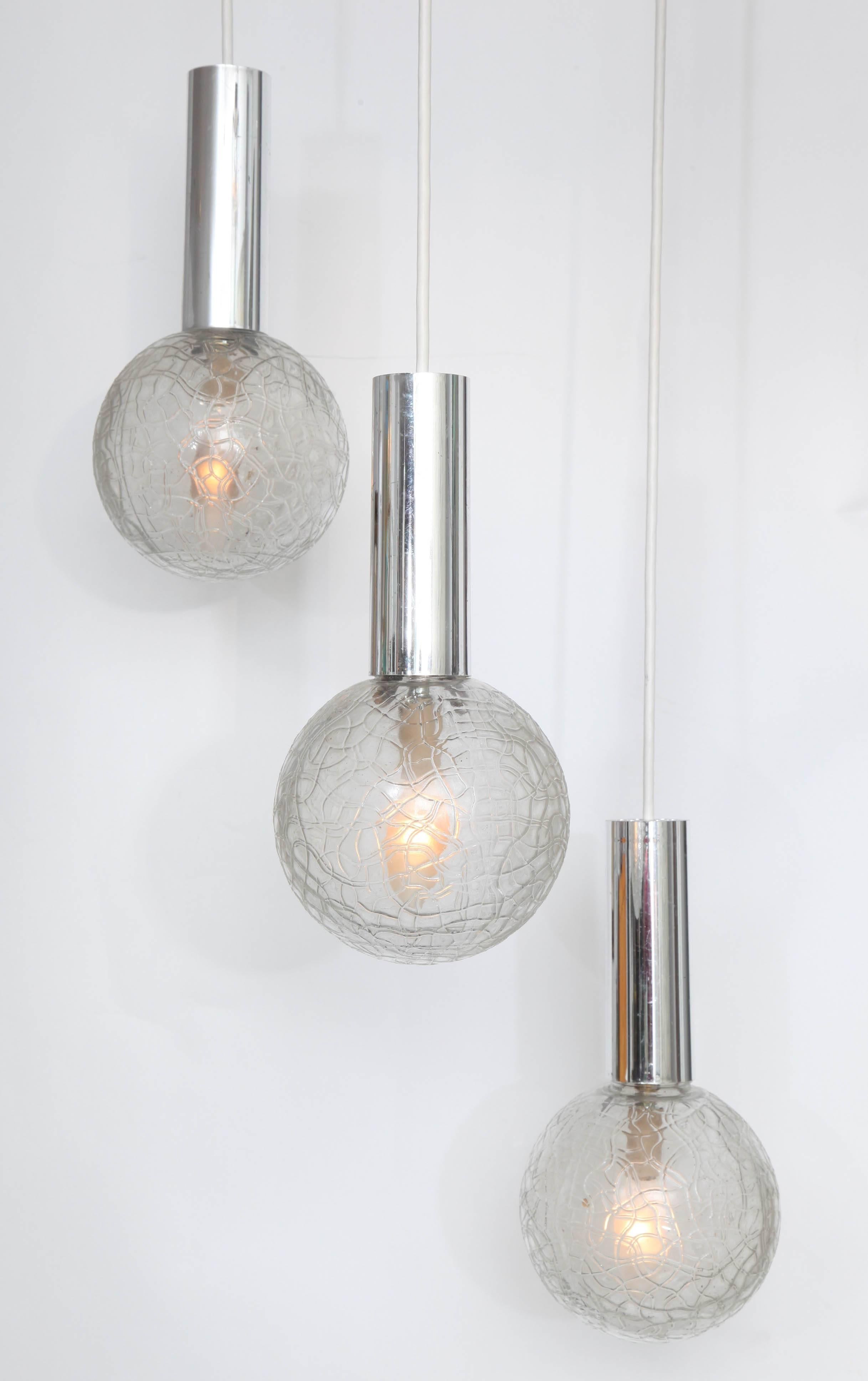 A great crackle glass Mid-Century pendant light fixture with three glass globes and chrome tubular fittings.