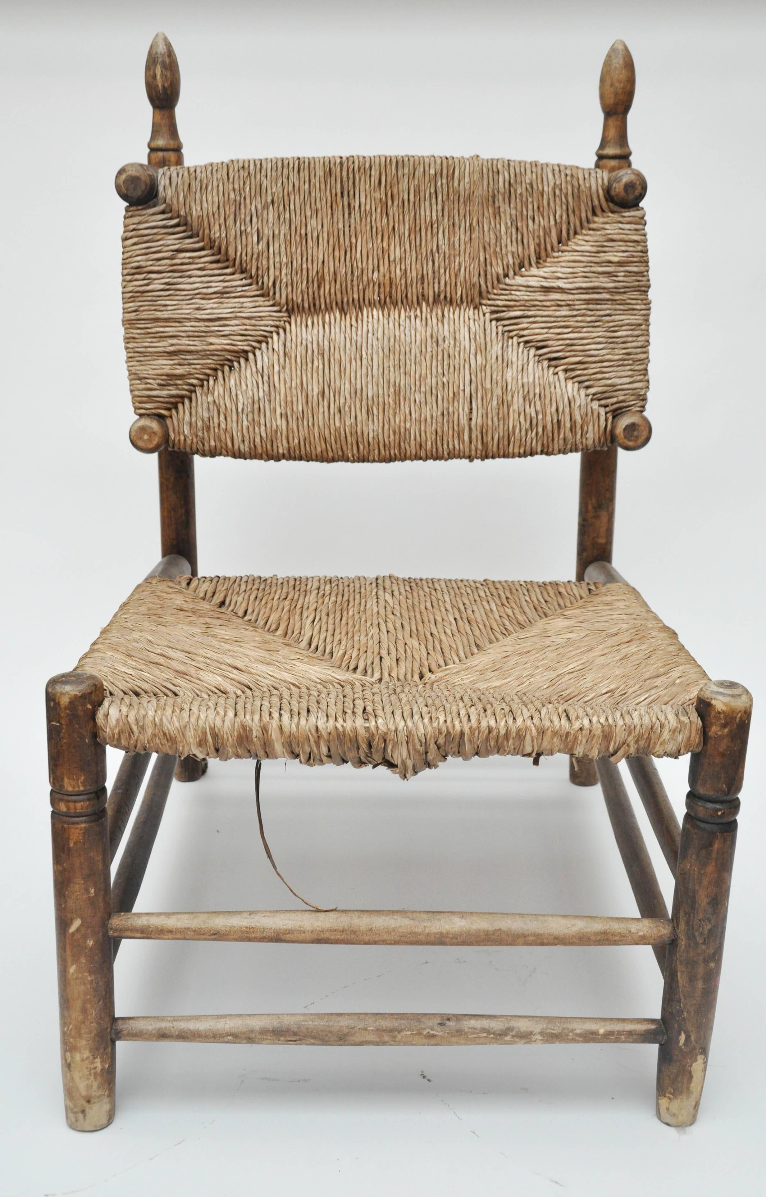 Early 20th century French rush slipper chairs. Found in France. Beautiful handcrafted rush seat and back and turned leg details. 
Unique shape and size. Would be great at the foot of a king-size bed

Dimensions: 21.5" W x 21" D x