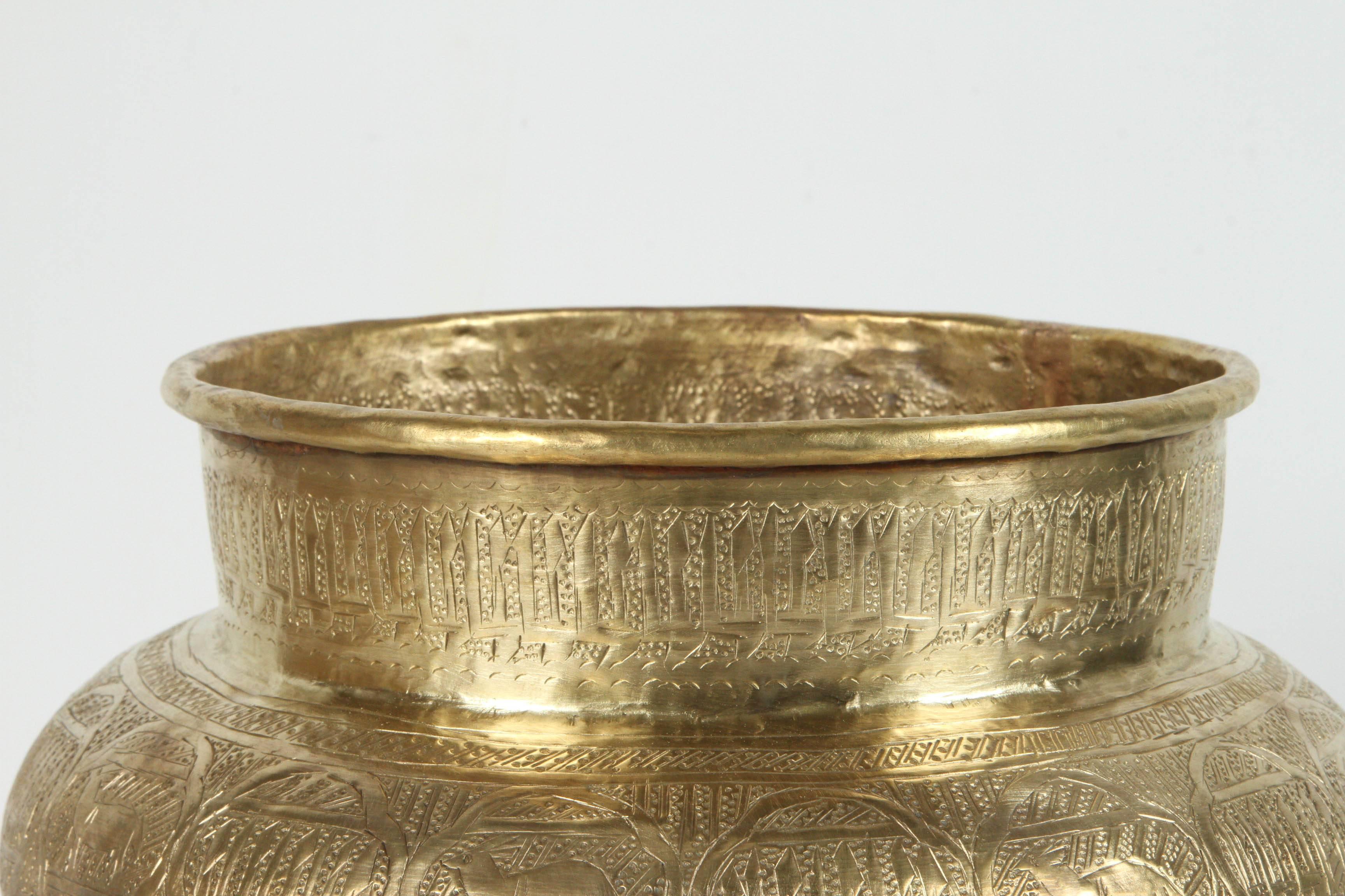 Large Middle Eastern Islamic finely hand-etched brass memorial bowl decorated with medallions with Hebrew inscriptions, pyramids, sphinx, and human figures the motifs are from the period of slavery in Egypt.
 Could be used as a jardinière, cache