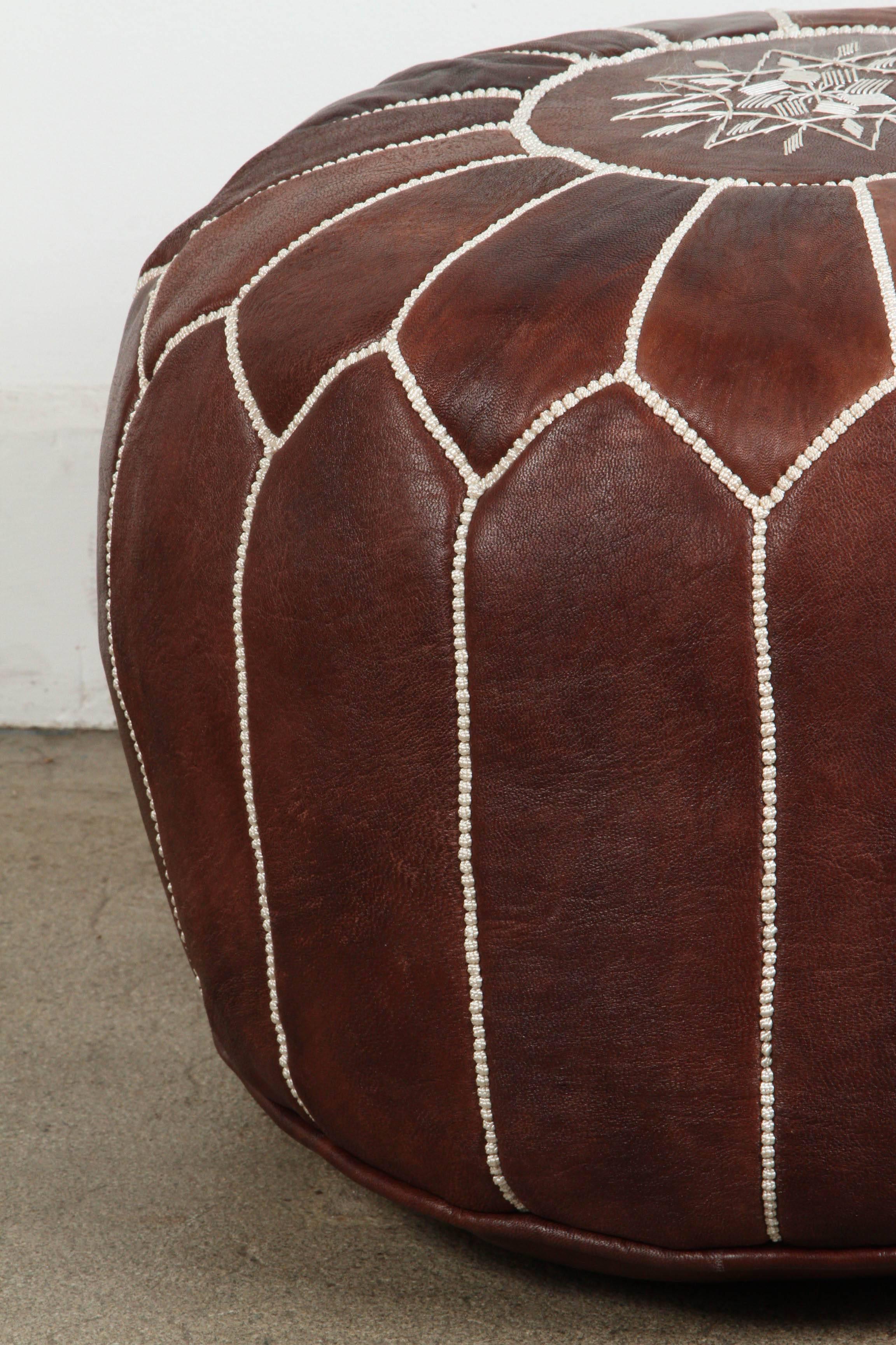 Moroccan handcrafted brown leather ottoman, with embroideries.
Could be used as a stool, side table or ottoman.
The Moroccan leather poufs are hand-tooled and embroidered with white thread.
Very nice handmade Moroccan dark brown color leather
