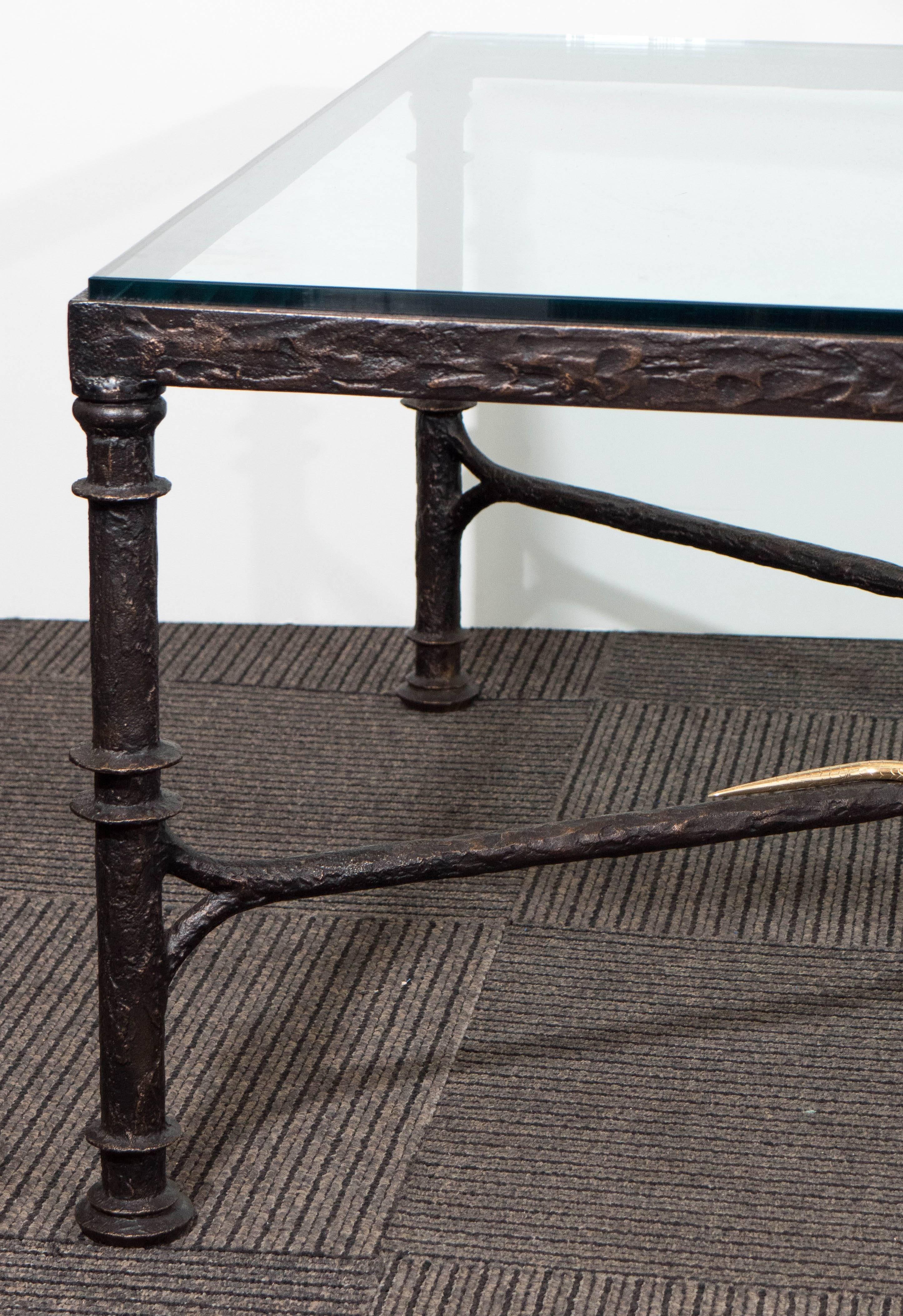 A stunning glass top low coffee table, created circa 1980s by designer Christopher Chodoff (1909-1990); the 'Etruscan' table, so called for the masterful rendering of the table's patinated cast bronze frame, includes a cross beam stretcher, artfully