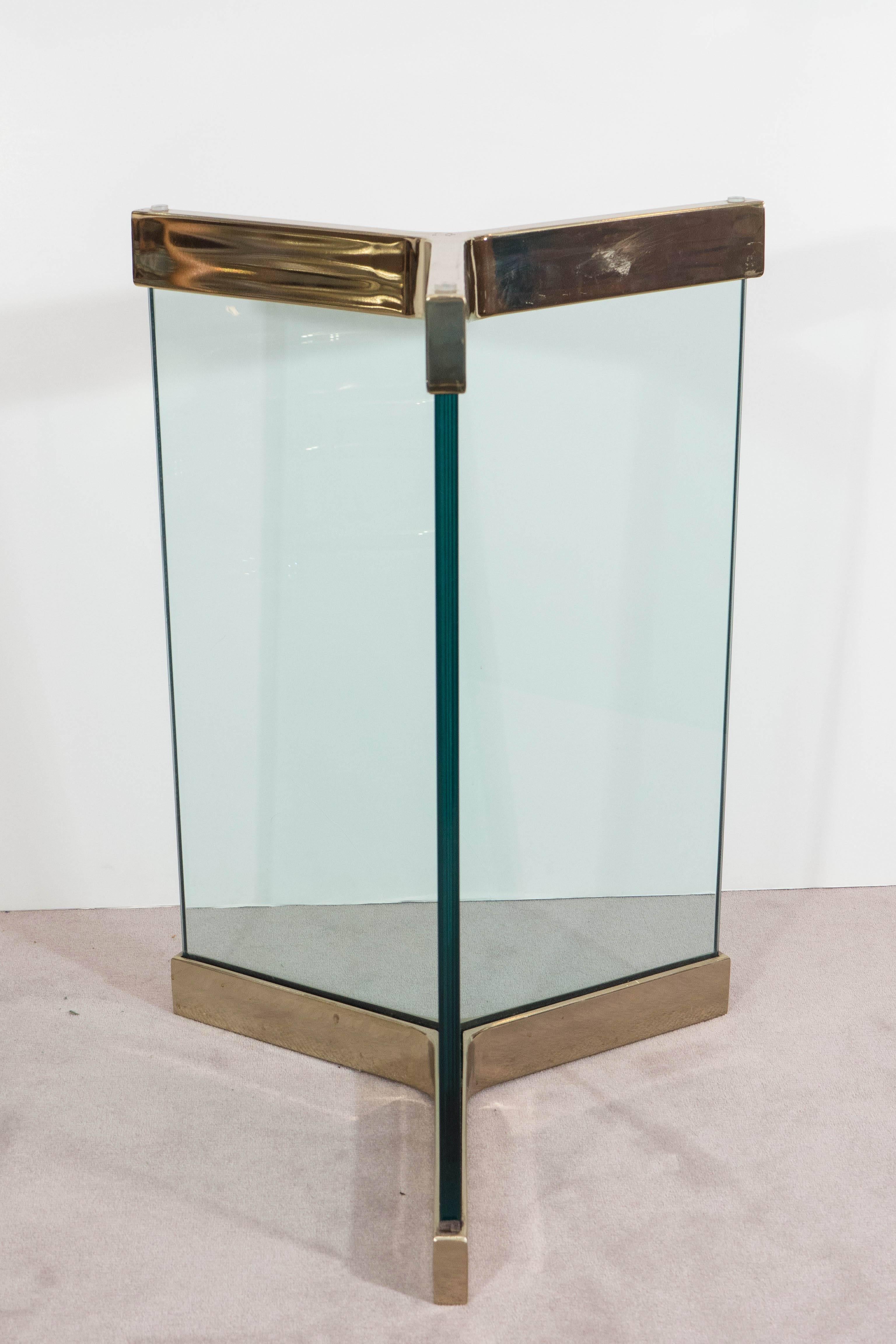 A pair of vintage table bases for a dining table, designed circa 1970s by Leon Rosen for the Pace Collection, each with thick, three-sided glass panels, framed to the top and bottom in polished brass. Very good condition, with age appropriate wear.