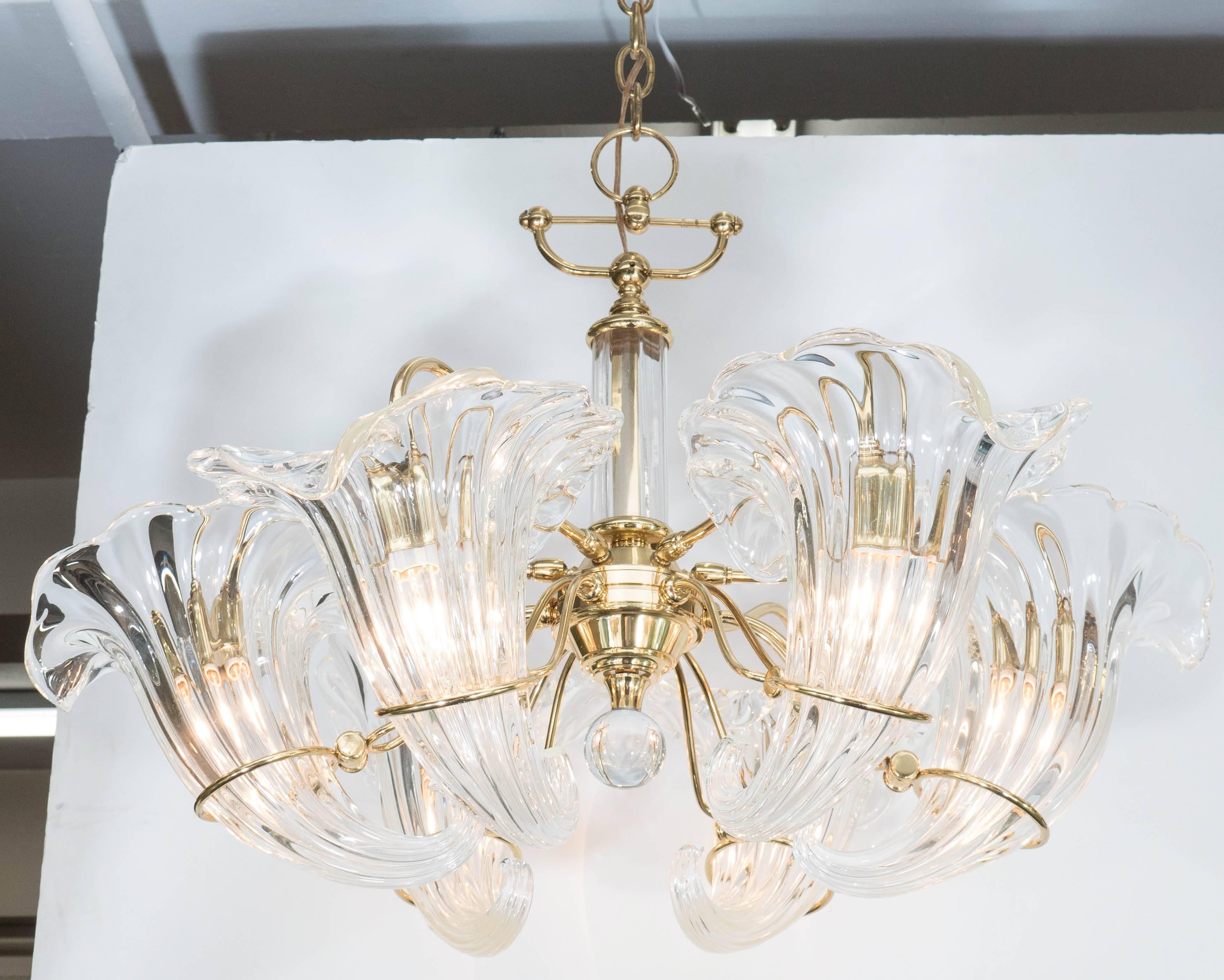 A vintage six-light Italian chandelier, designed circa 1970s by Franco Luce, the frame in beautifully polished brass, with crystal ball finial, and clear Murano glass cornucopia inserts as shades. Wiring and sockets to US standard, requires six