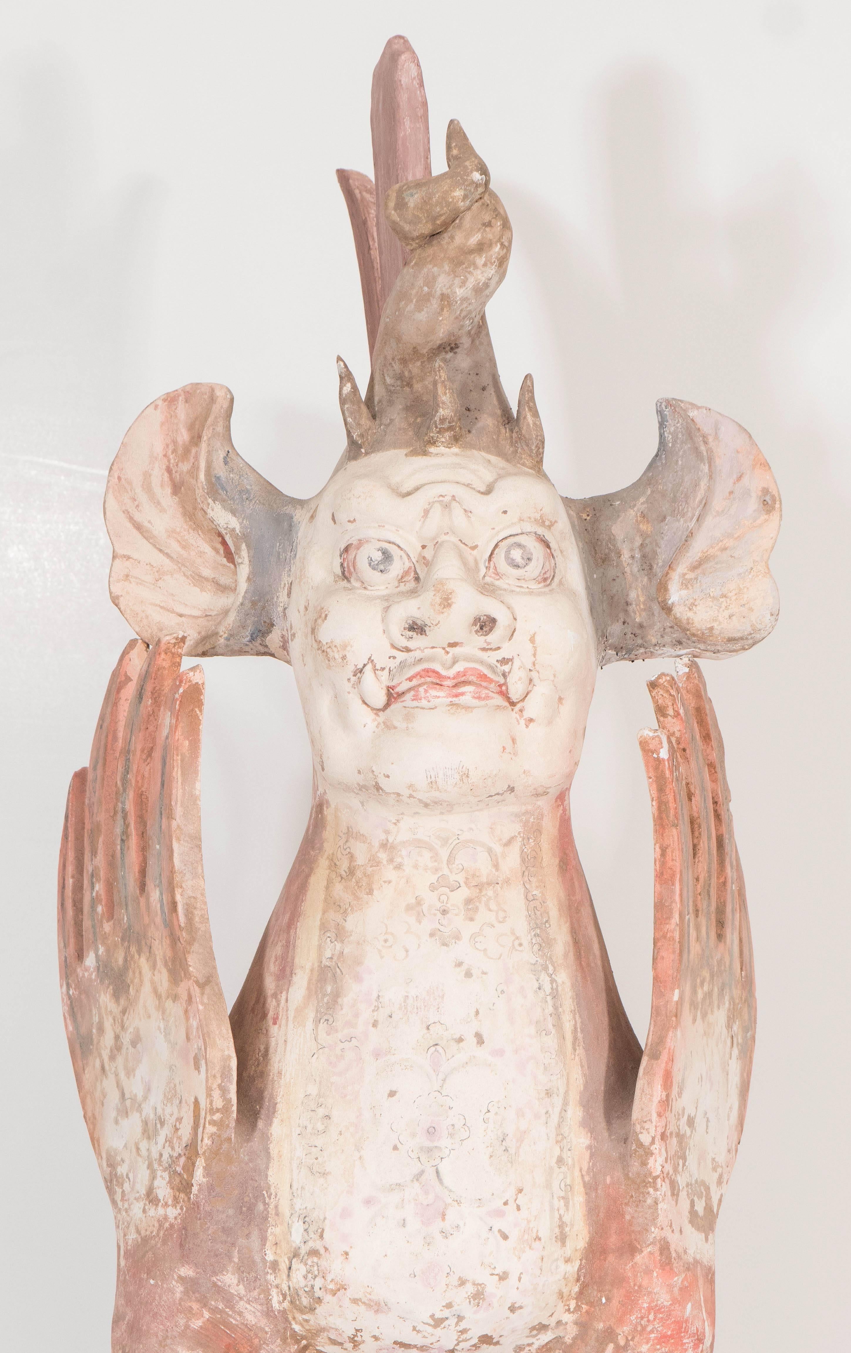 This pair of ancient Chinese earth spirits, or zhenmushou (grave-quelling beasts), in unglazed pottery, which date back to the Tang Dynasty, were considered guardians of tombs, their fearsome visage used to ward off intruders, as well as prevent the