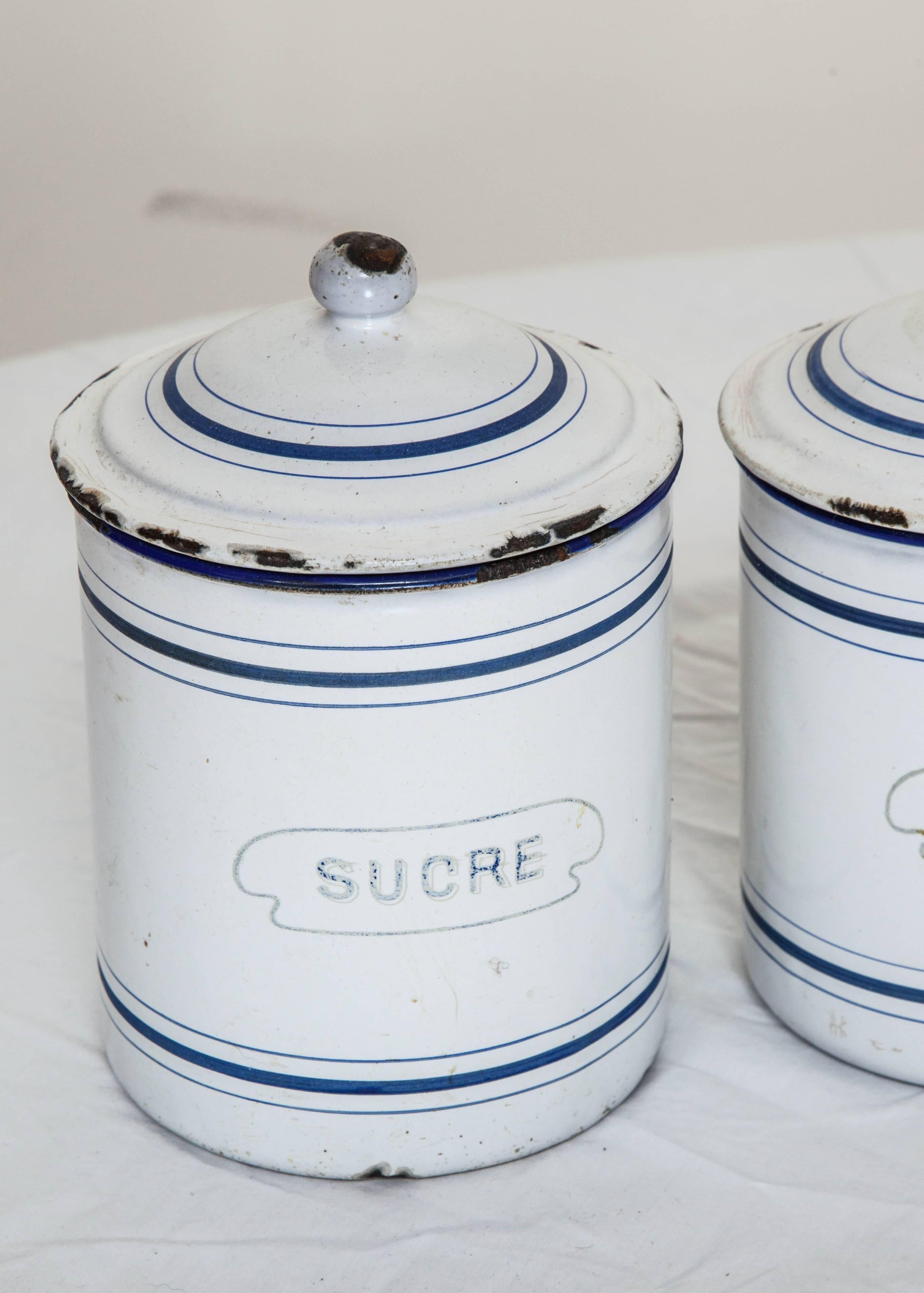 Set of six antique French pantry tin canisters with lids and original paint. 