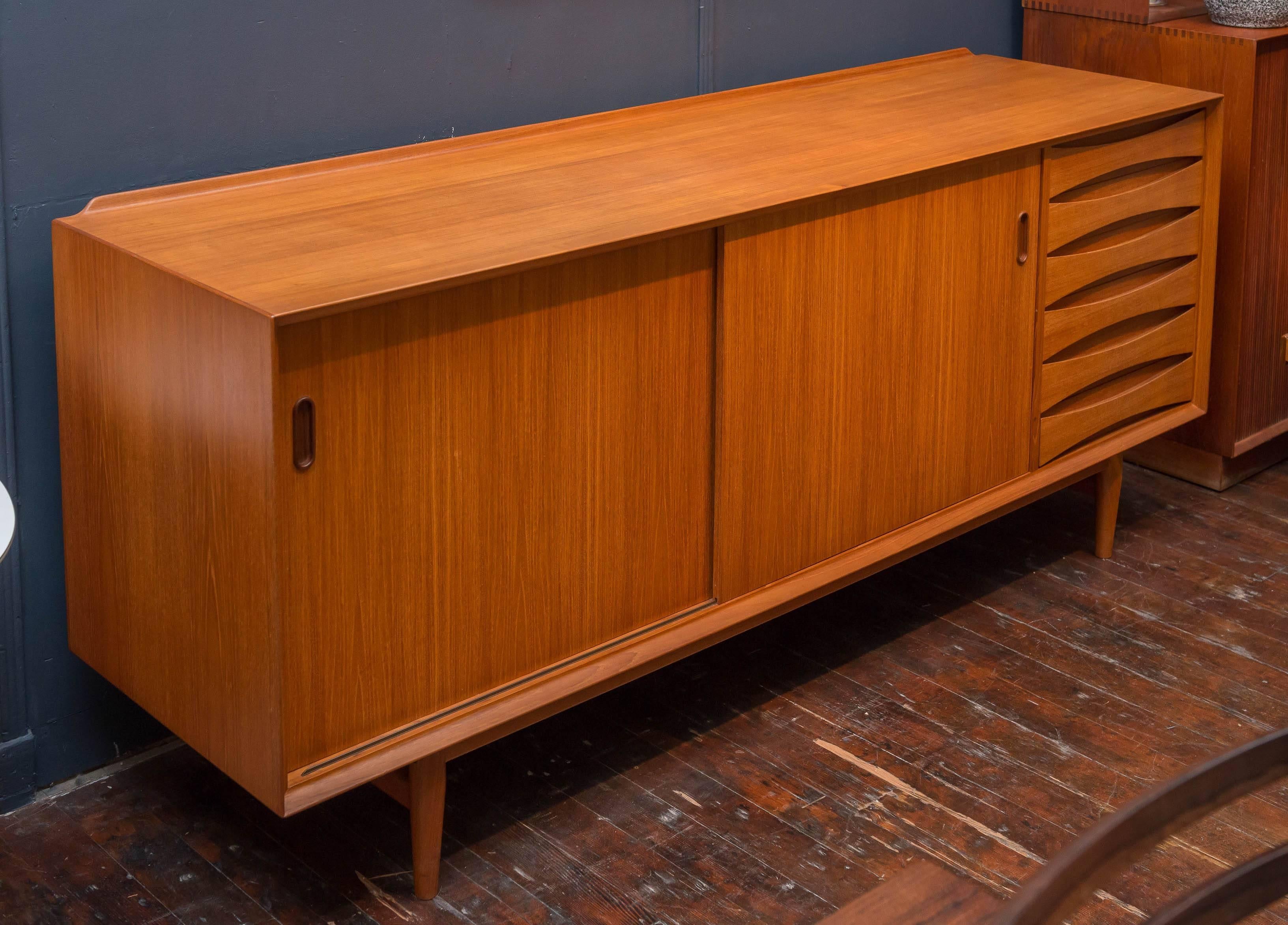 Arne Vodder design teak credenza for Sibast Furniture co, Denamrk. Acquired from the original family whom purchased it in Europe in the late 1950's. 
Three adjustable shelves and a sculpted trim across the top back, ready to enjoy.