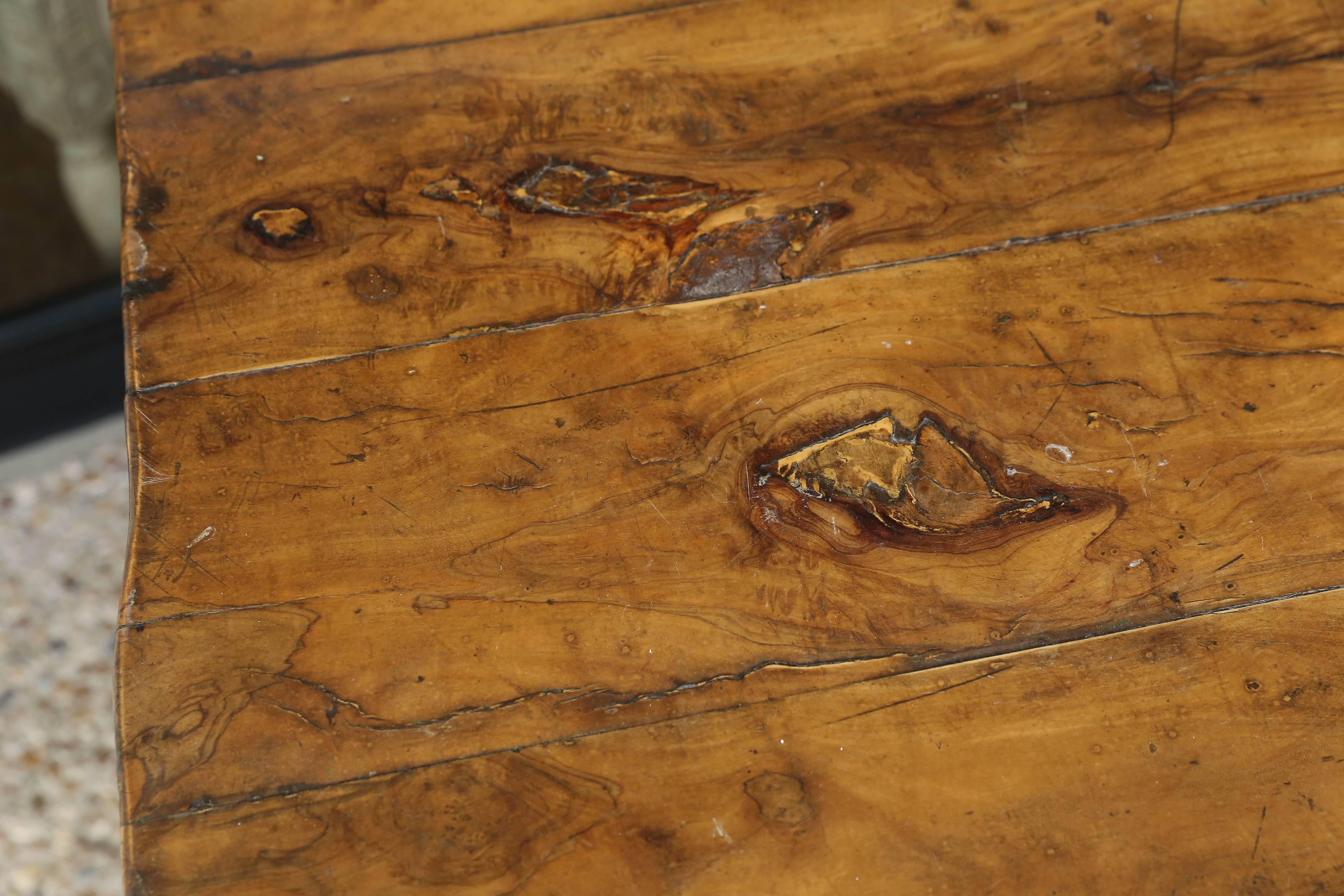 Decorative vintage Belgian root base table with walnut top cut in an irregular natural shape.