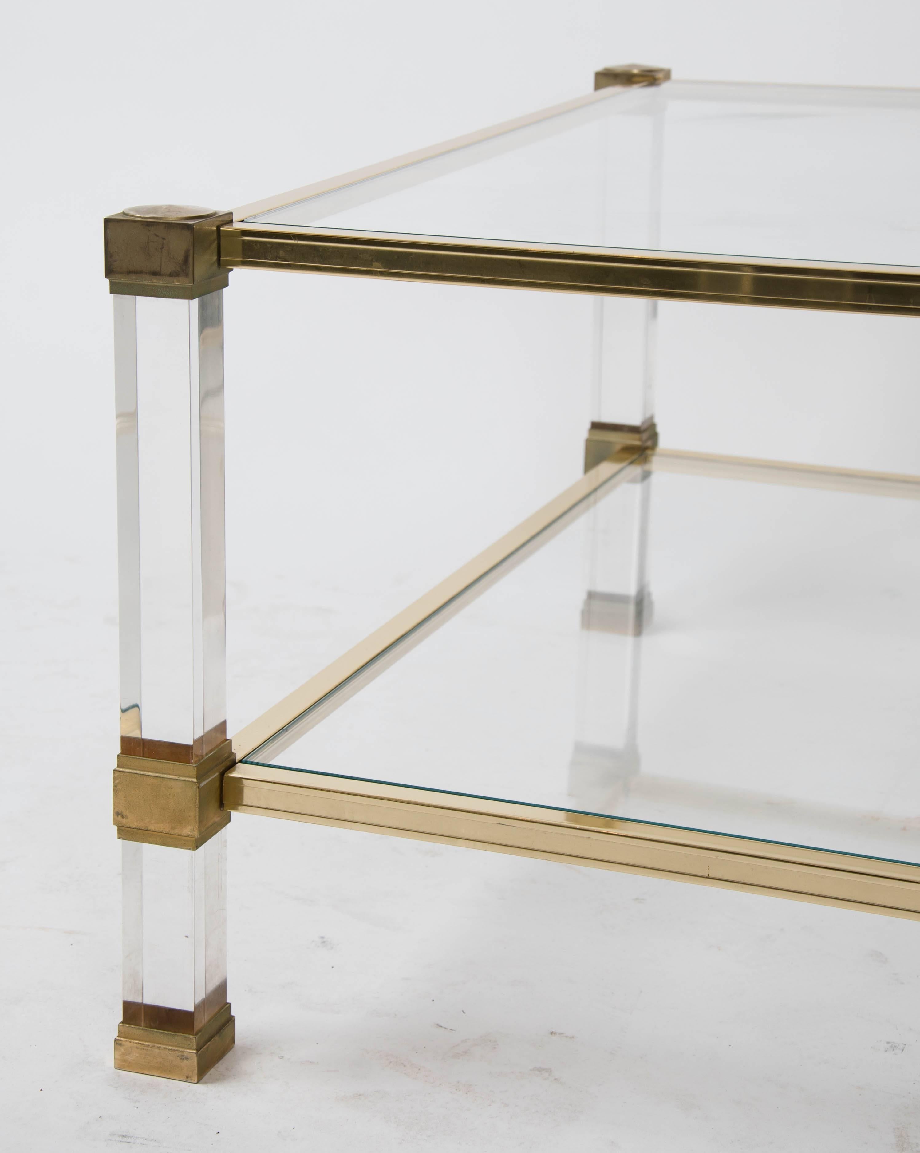 Coffee table by Pierre Vandel (Paris) in Lucite and gilt metal with glass top and
shelf, circa 1975.
