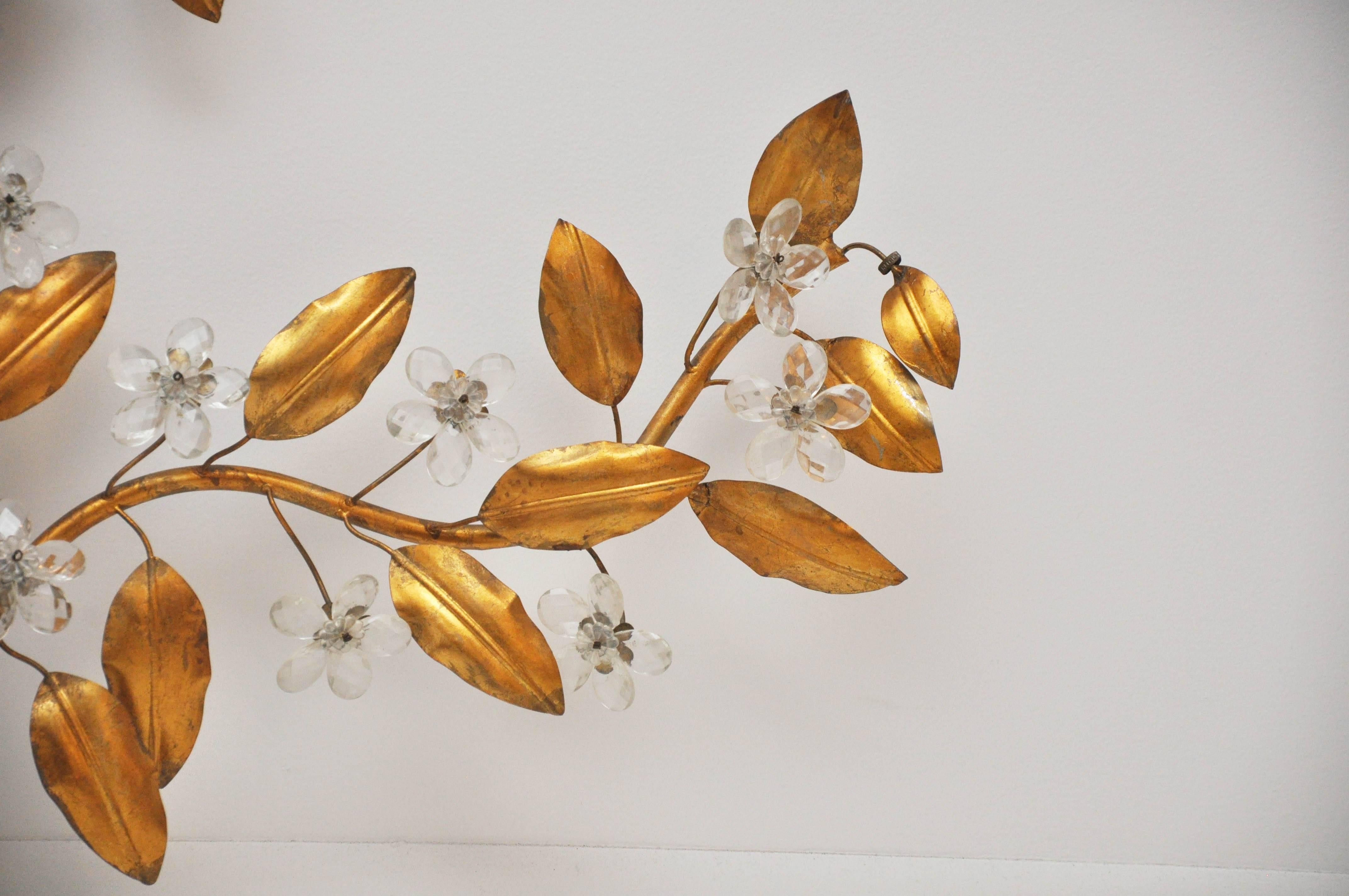A sculptural work of art! Adds beauty and depth to the walls with beautiful gold leaves and crystal flowers. 