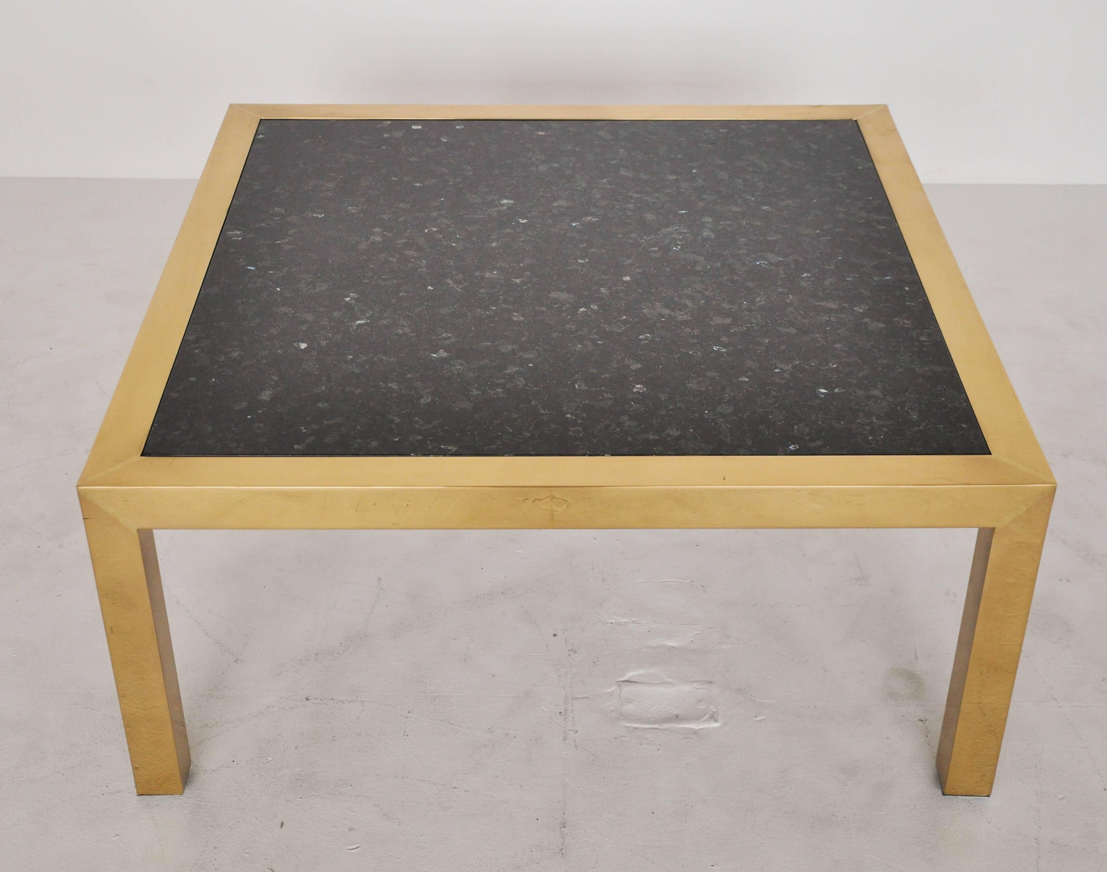 Brass frame coffee table with black granite top, circa 1970s.