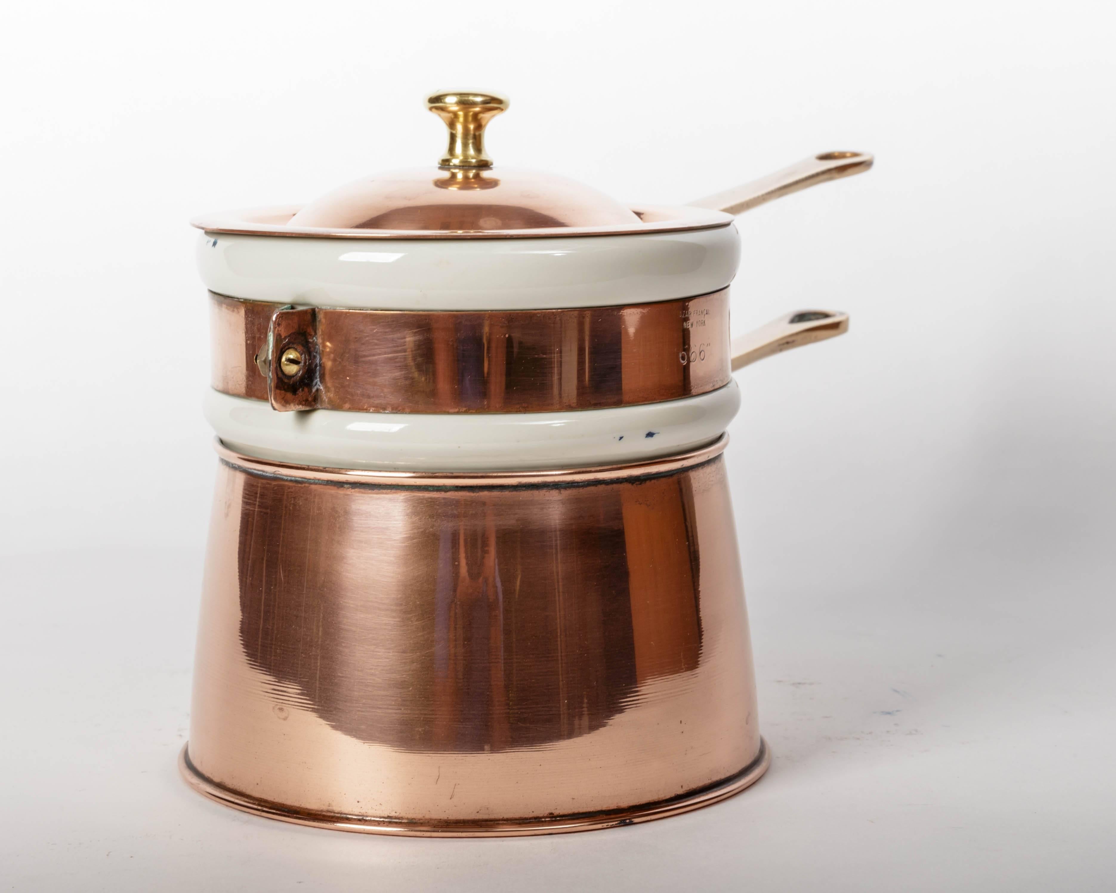 Copper and brass double boiler with white ceramic pot marked hall. The ceramic pot has a copper band with a brass handle marked 