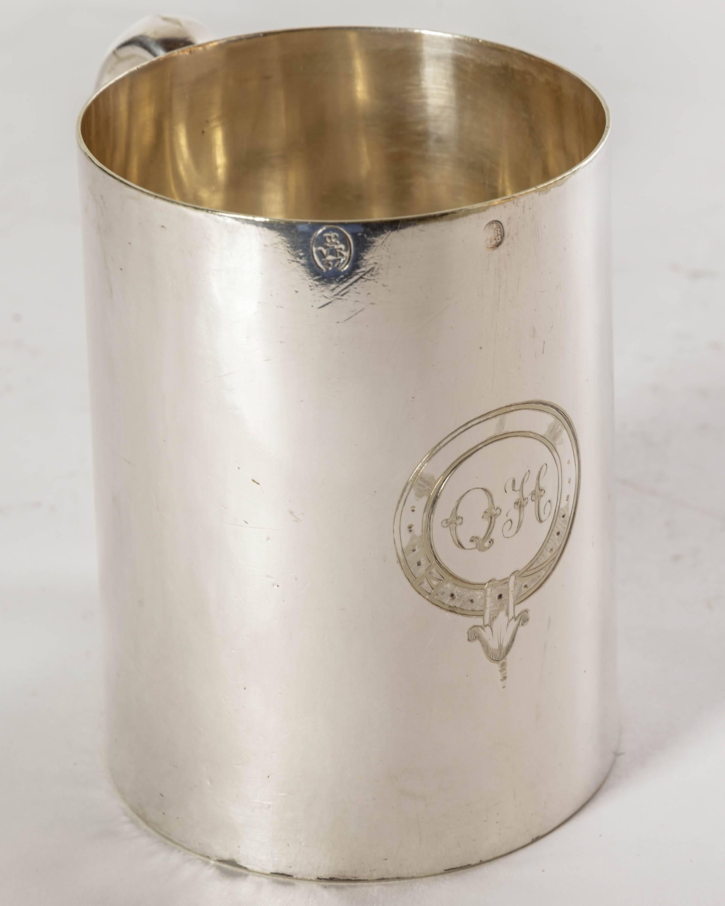 English Victorian silver plate tankard with decorative engraved belted cartouche having the initials Q H. The tankard is a plain simple design on which are three imprints with VR (For Victoria Rex - Queen) two with crowns and pint. Bottom is