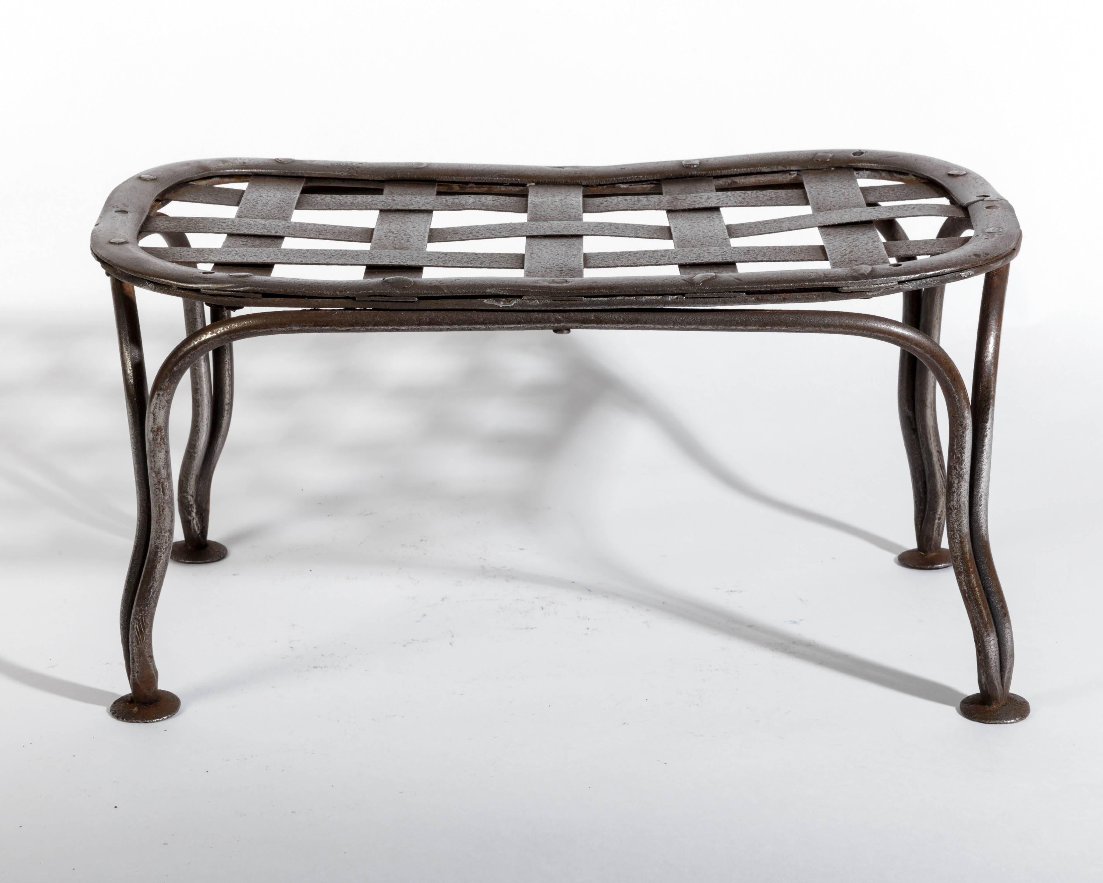 French polished steel Napoleon III garden footstool. Used by women to elevate their dress hems off the grass or gravel. The footstool would match the design of the garden chair. A very unusual piece of garden furniture. The legs have a slight