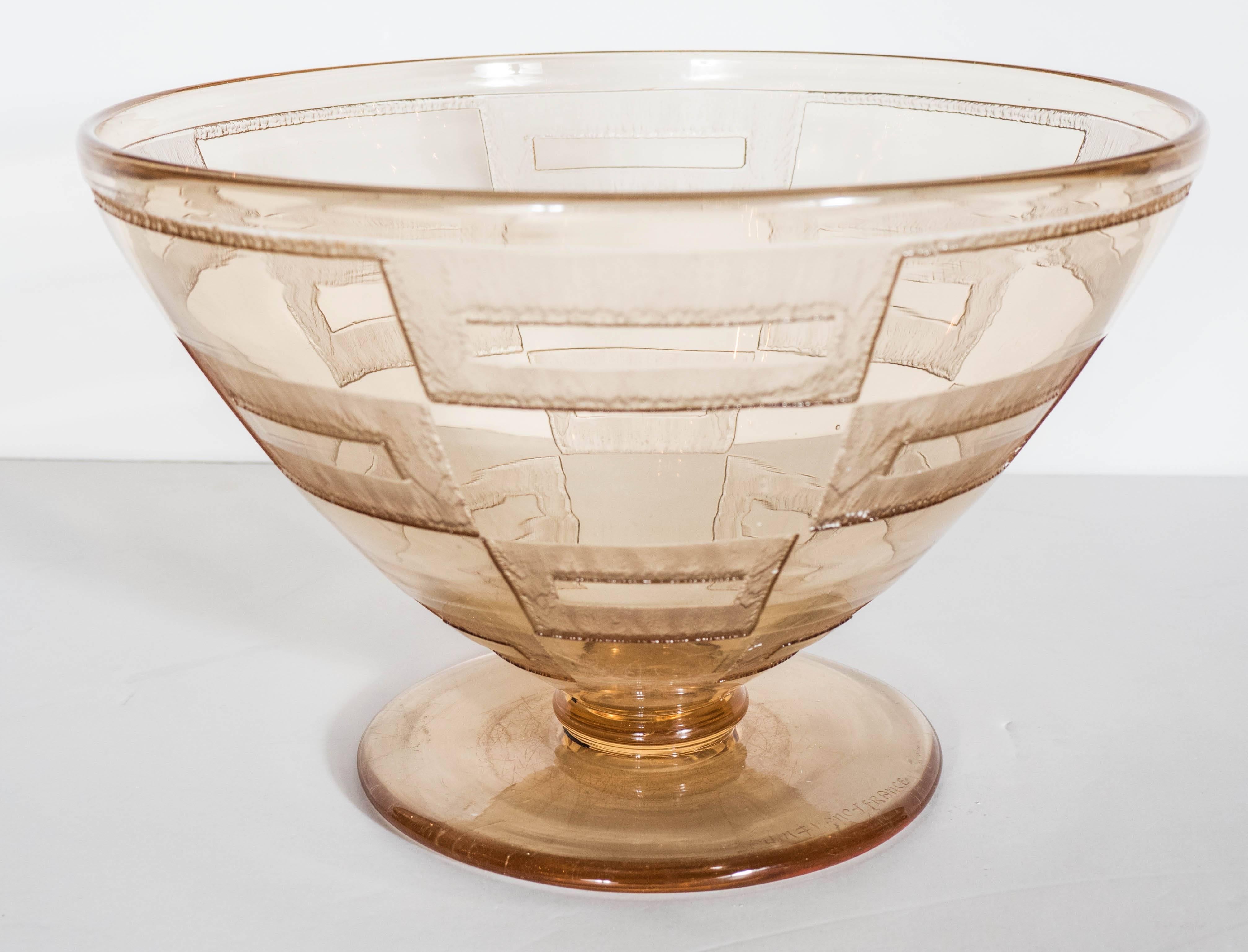 Elegant and exquisite pair of Art Deco pale amber glass footed bowls by Daum, Nancy (France) with an acid-etched geometrical pattern. Engraved signature on the foot, 