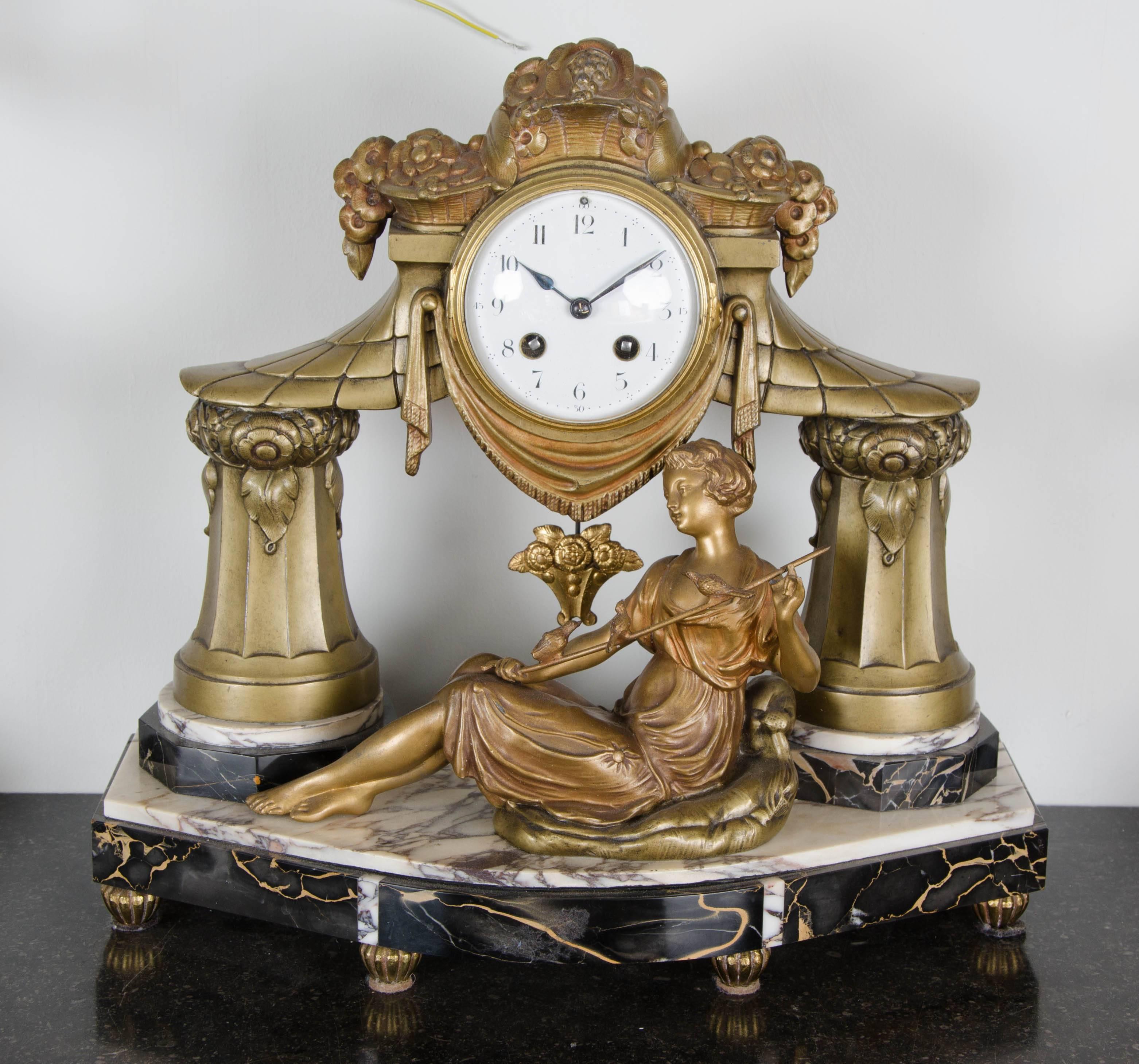 A French Art Deco clock garniture, signed Limousin. Patinated spelter and Portoro and Violet Breche marble.

Movement by Societe Clusienne S.C.A.P.H. of Cluses. With chime.

In working order.