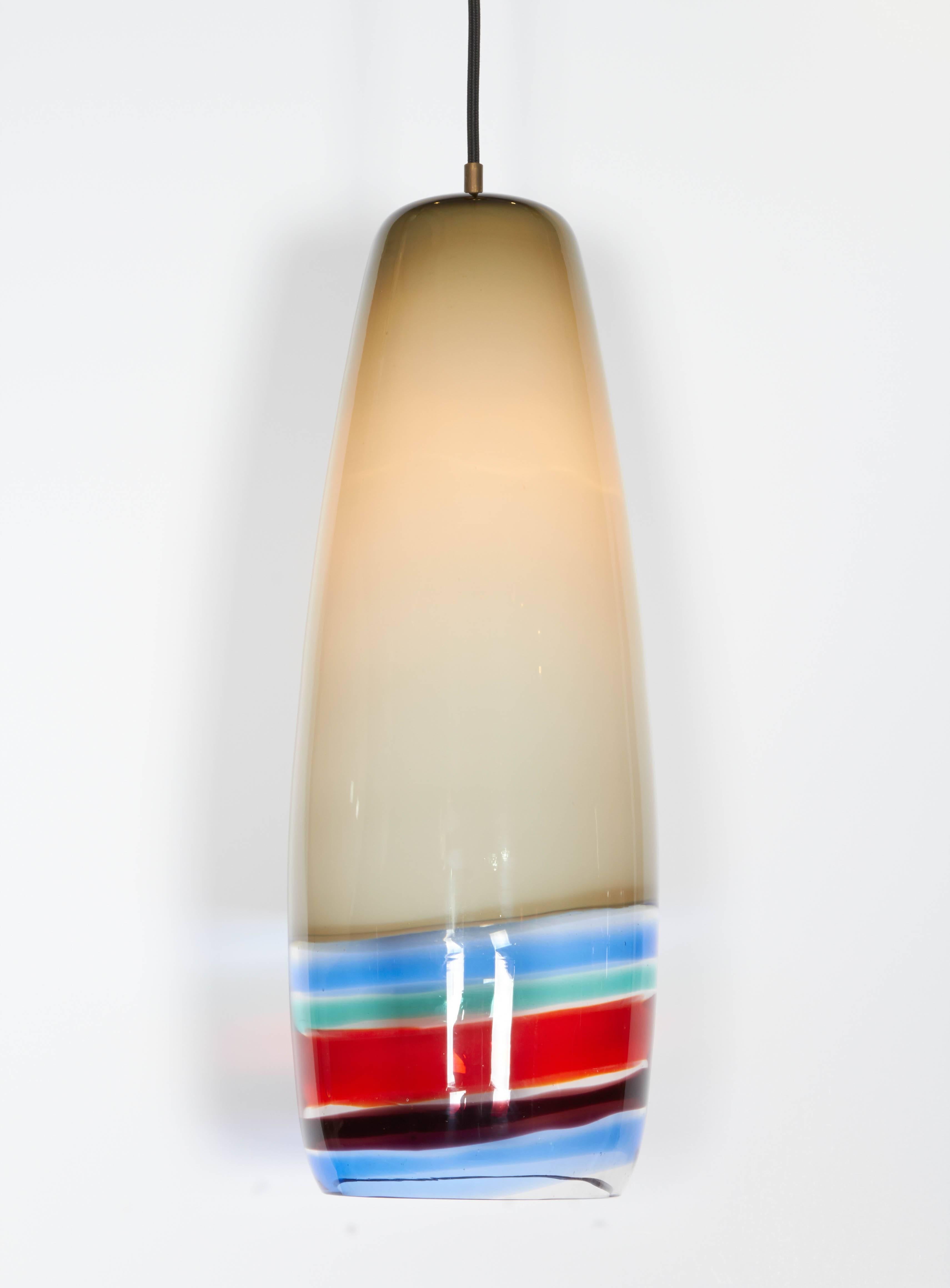 This ivory and color banded pendant lamp by Massimo Vignelli is ideal for a high ceilinged entry way. The bands of color adds a cheerfulness to the design.