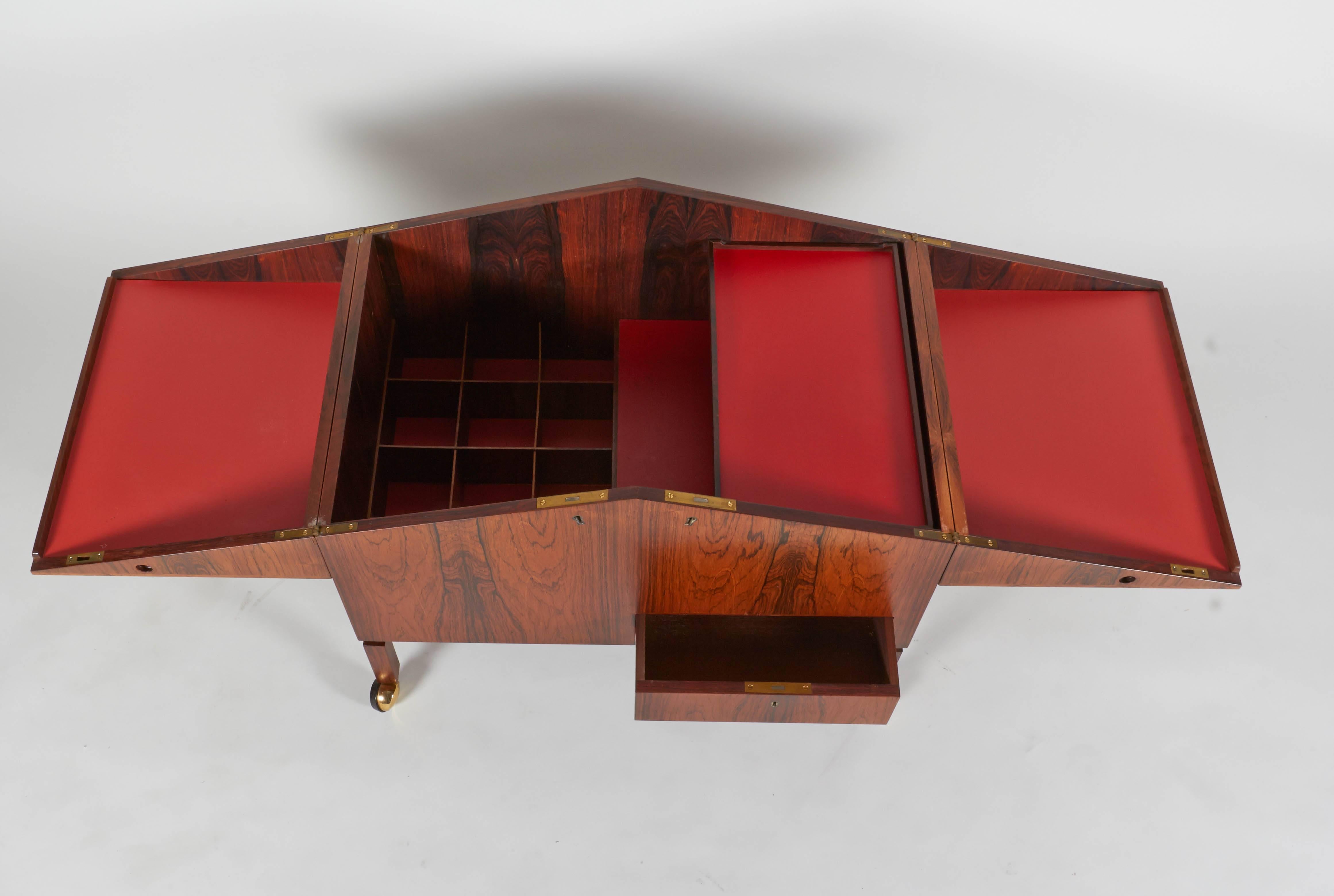 This bar cabinet is simply an amazing piece of Danish craftsmanship. The remarkable details and the wonderfully grained rosewood make this a superior example of the period.