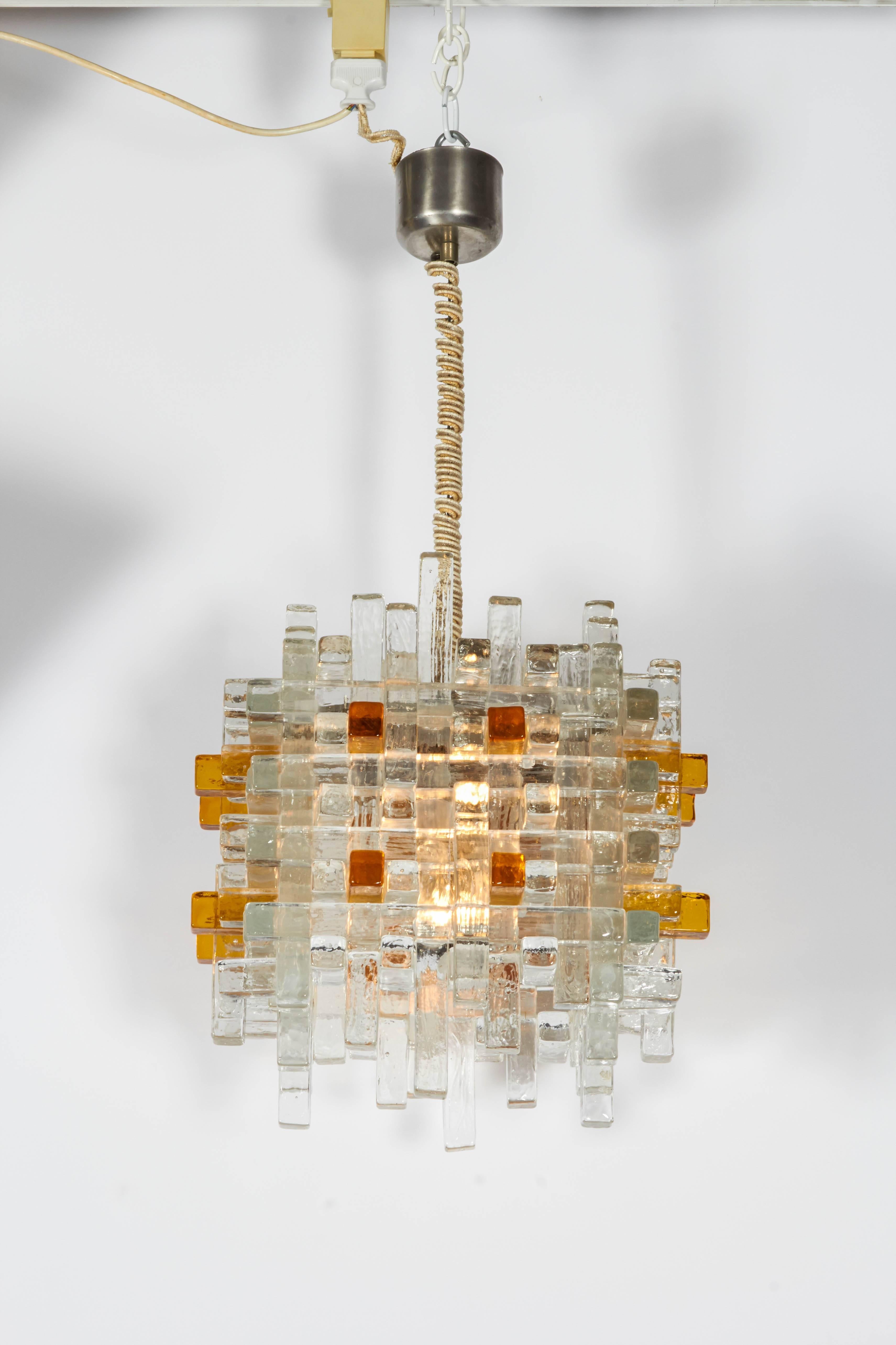 An innovative example of 1970s Italian design, this pendant lamp from Poliarte is constructed with clear and amber crystal rods. The height from the ceiling to the bottom of lamp measures 27 in.