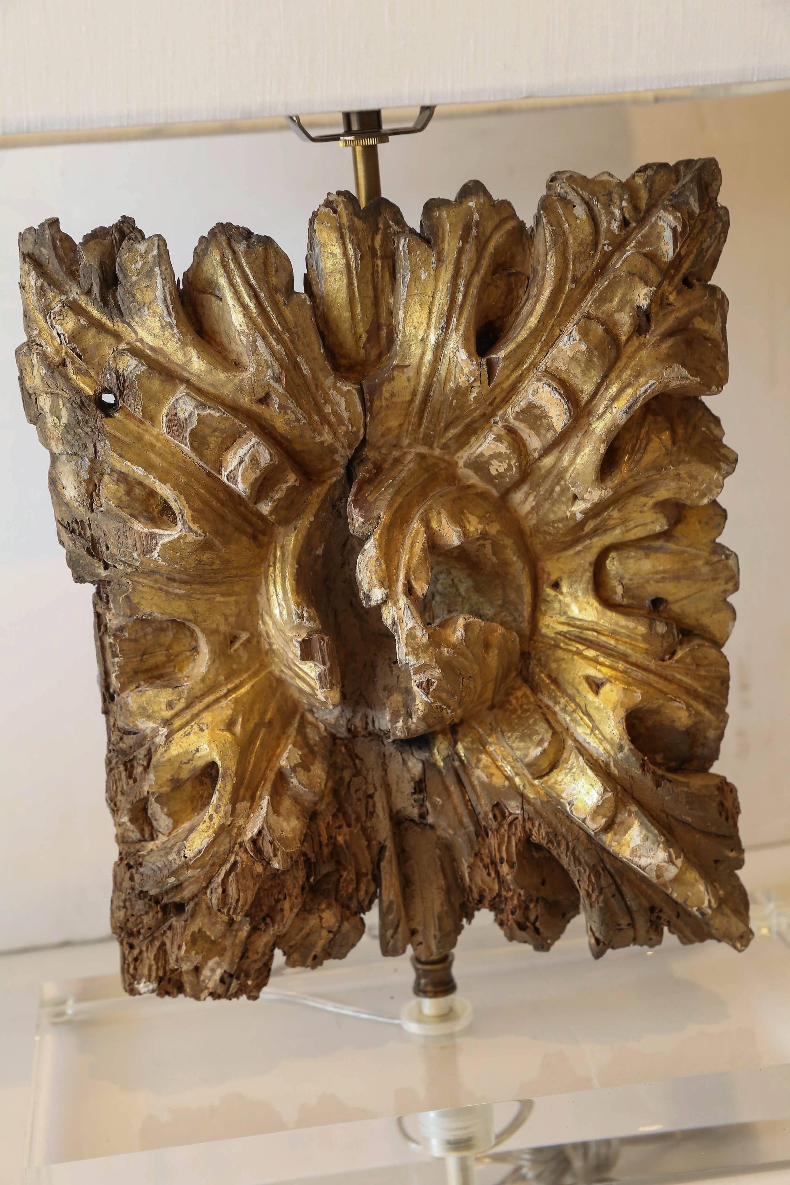 18th century gilded architectural fragment mounted on a Lucite base and newly-wired as a custom table lamp. Sold with a complementary linen shade (measurements include shade).